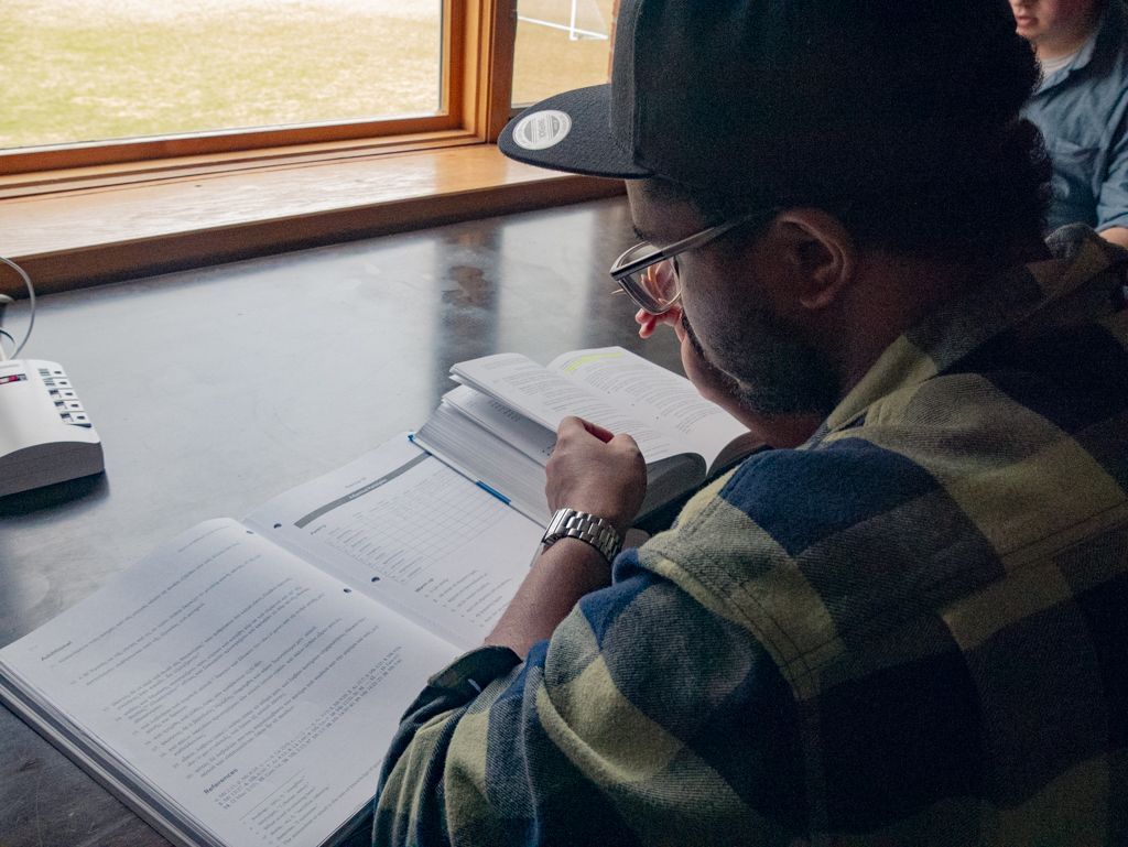 a student studying at a table in the student center
