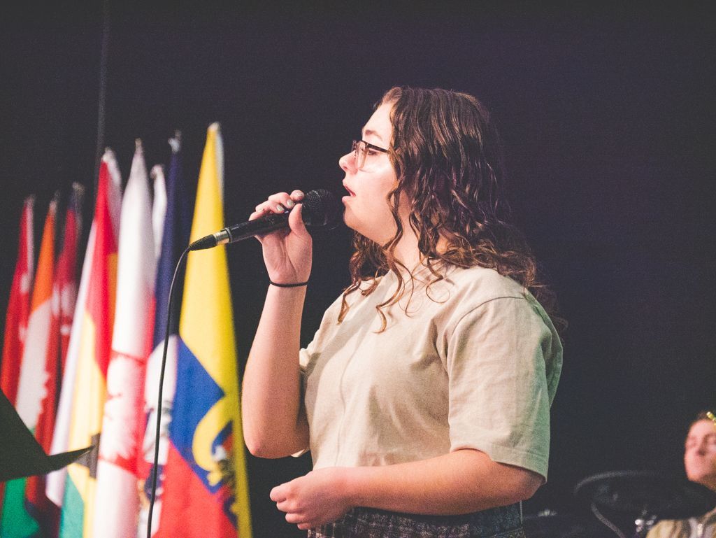 a student leading worship during a chapel service 