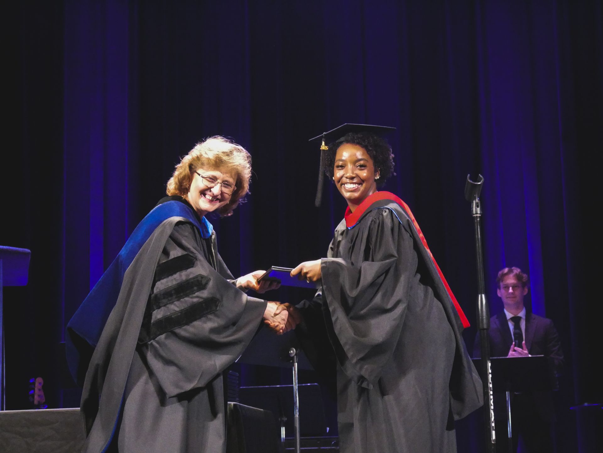 a student receives her degree at graduation