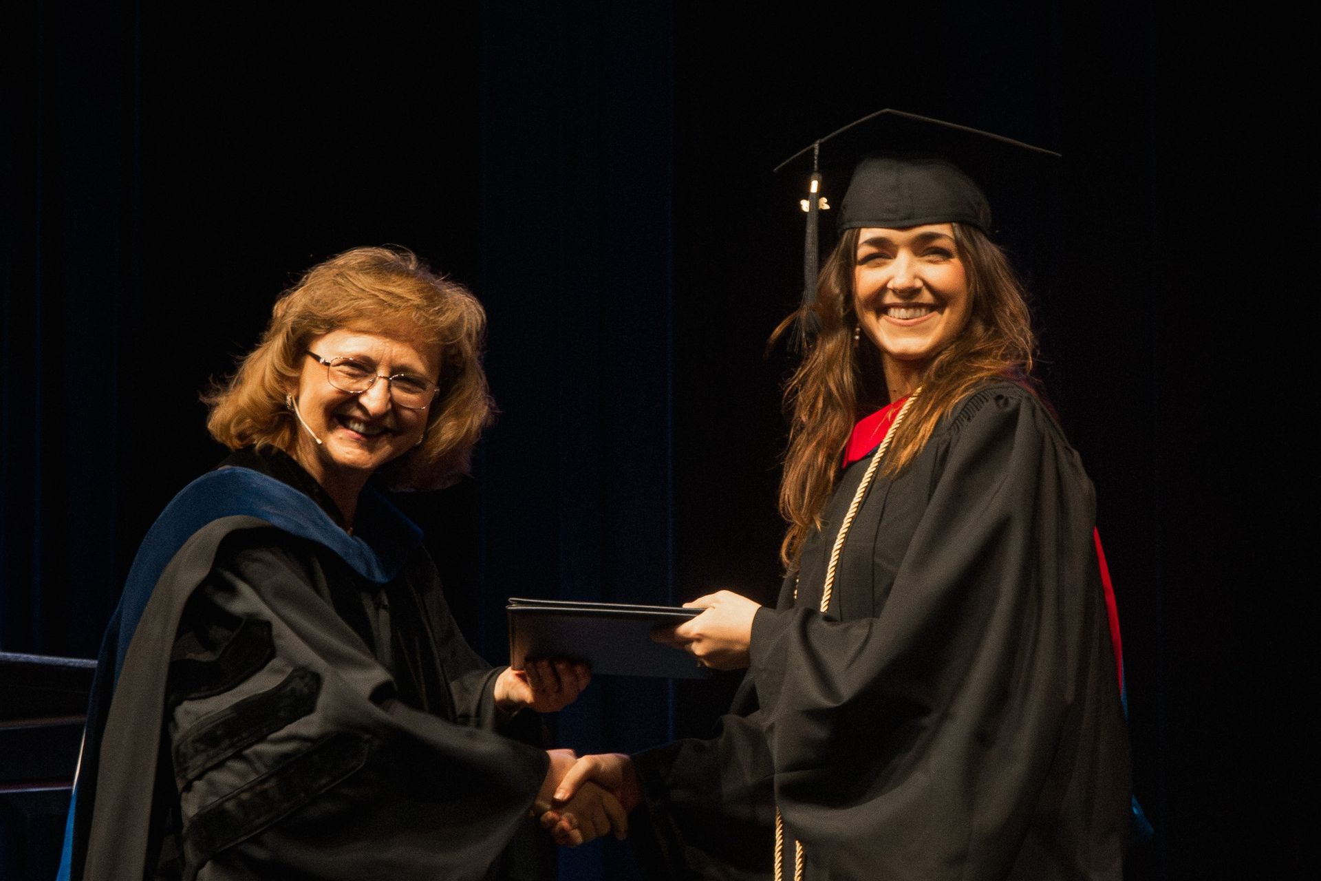 a student receives her degree at graduation