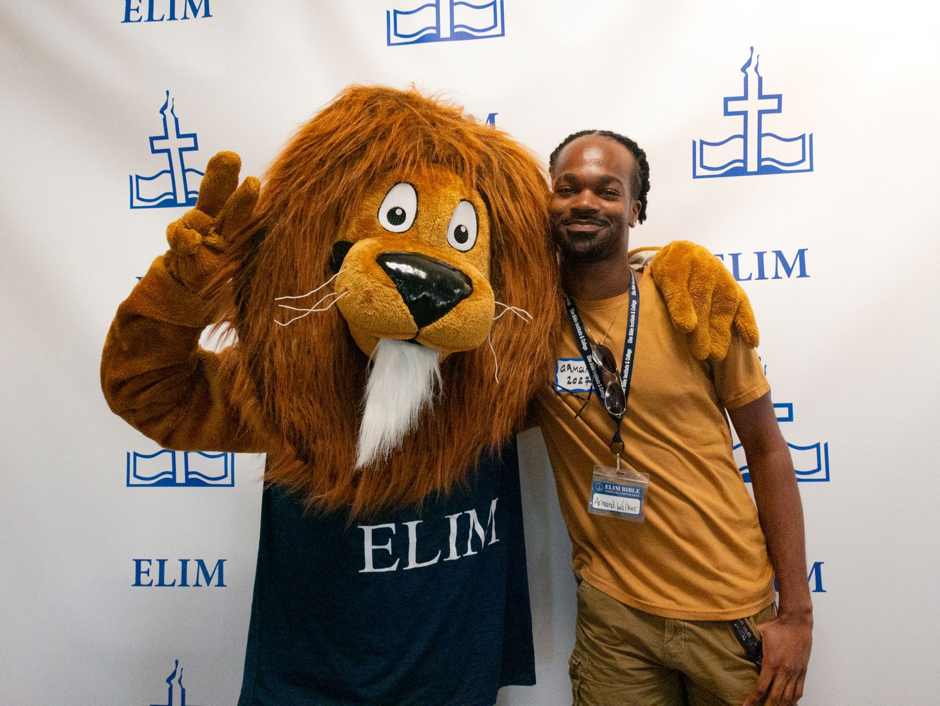 a picture with the mascot and a student 