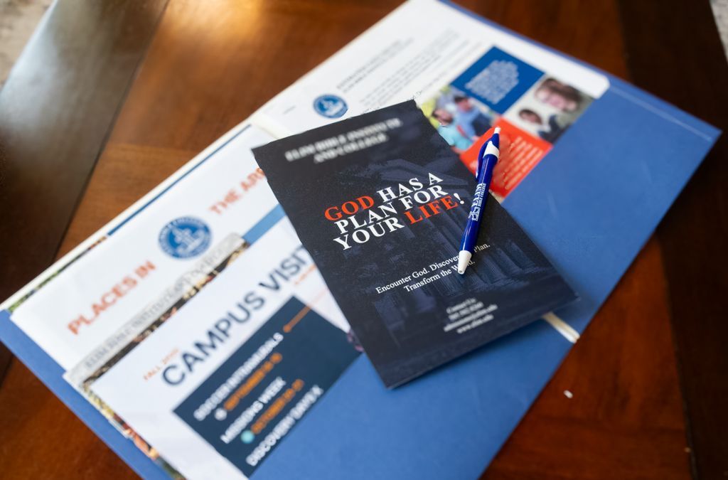A folder with a pen and a pamphlet that says God has a plan for your life