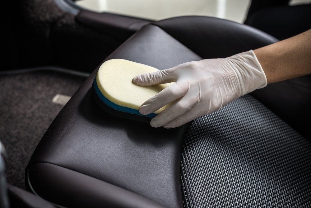 Man Cleaning the Car Seat — Windsor, CO — A&F Custom Upholstery