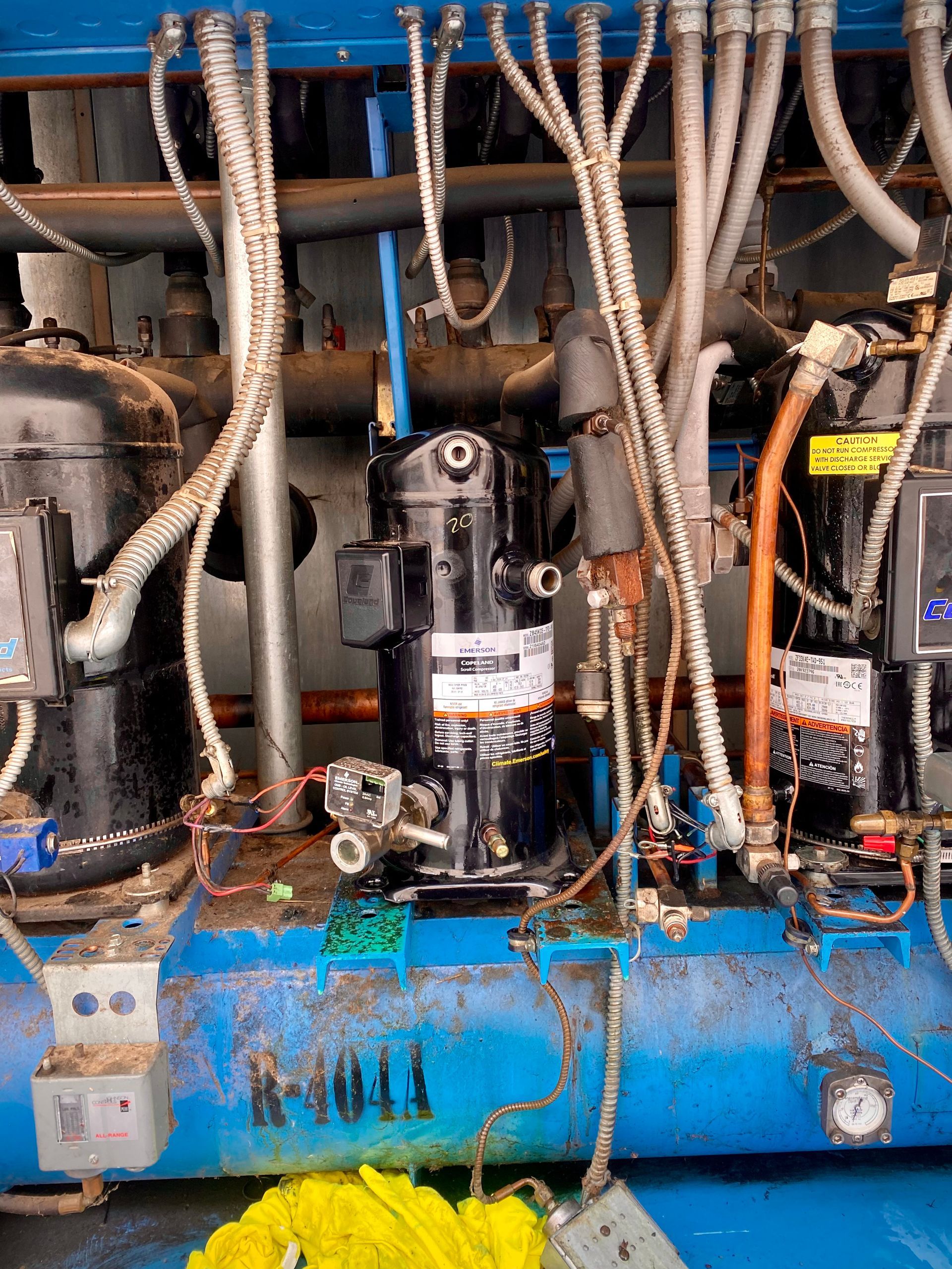 A blue machine with a lot of wires coming out of it