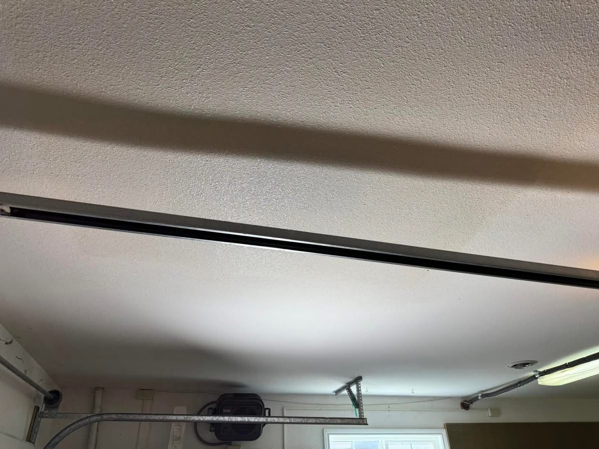 View of a garage ceiling with a track, potentially for a garage door, visible.