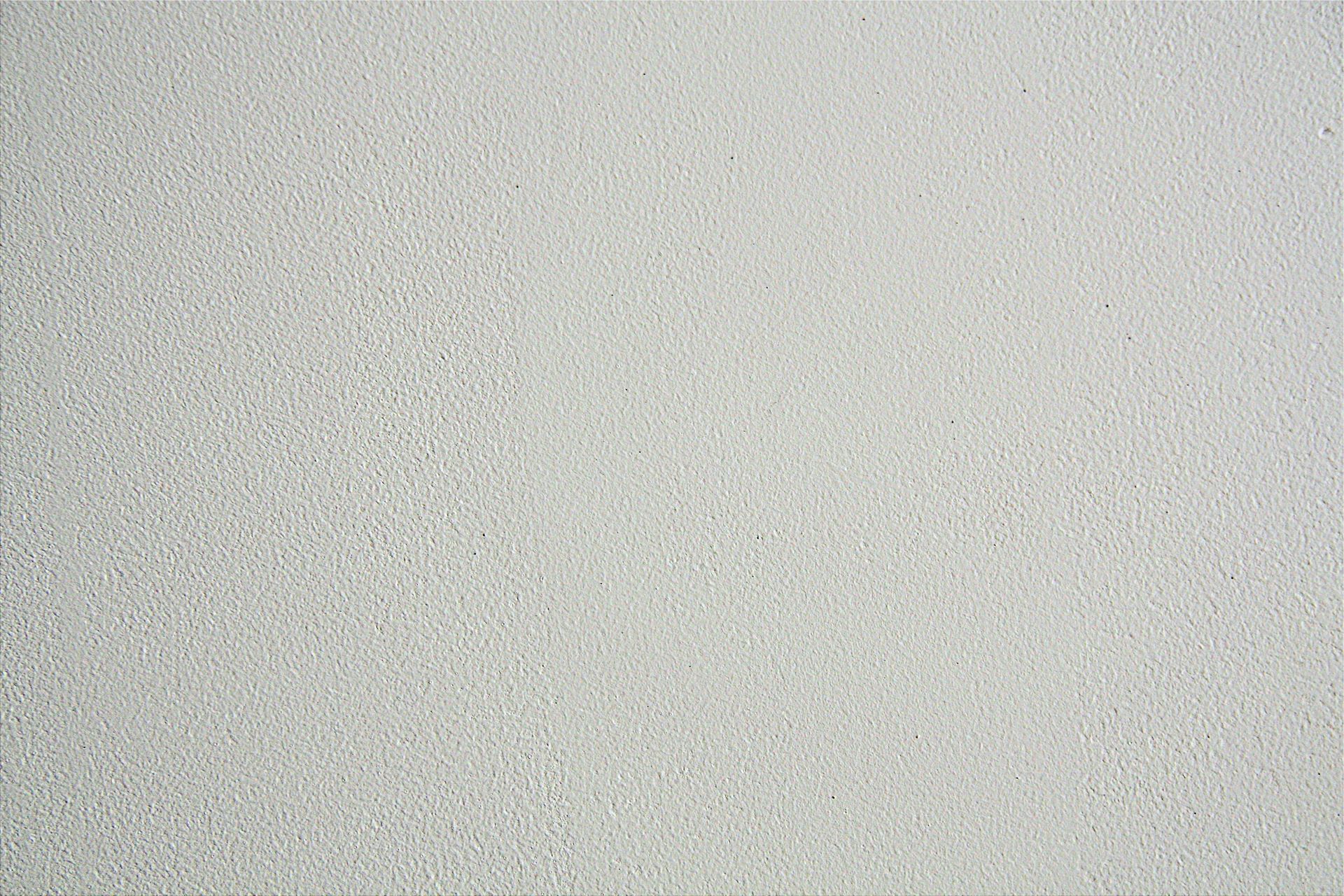 Light gray, textured wall.