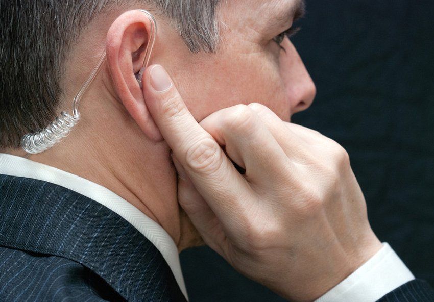 Close-up of a secret service agent listening to his earpiece