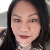 A close up of a woman 's face with long black hair.