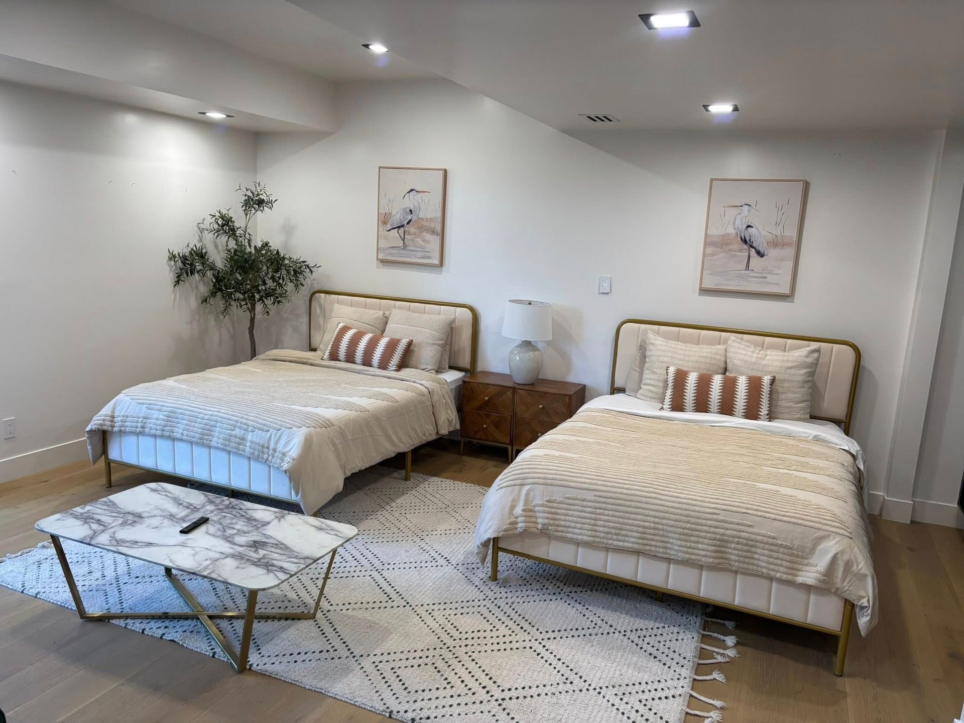 A bedroom with two beds and a coffee table.