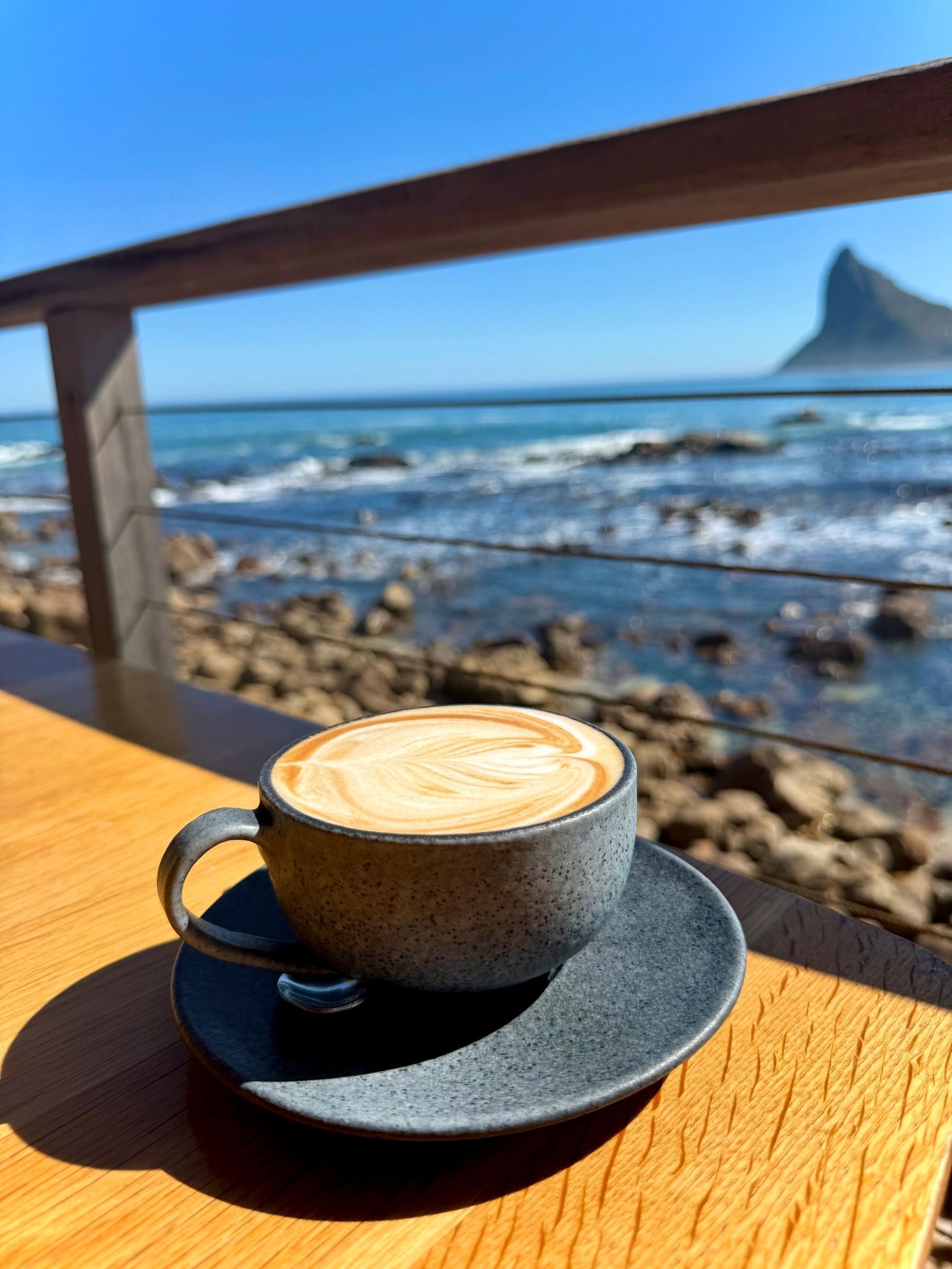 Flat white with almond milk overlooking the ocean at Tintswalo