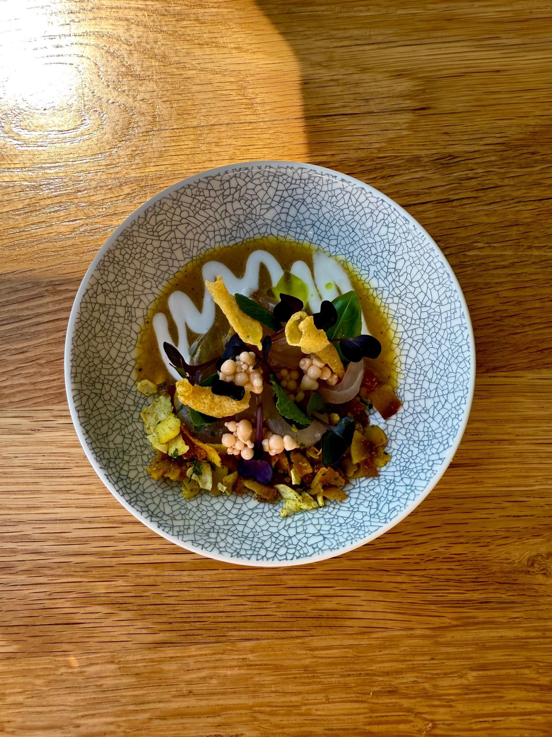 Line fish sashimi with sauce and herbs at Chef’s Warehouse Tintswalo