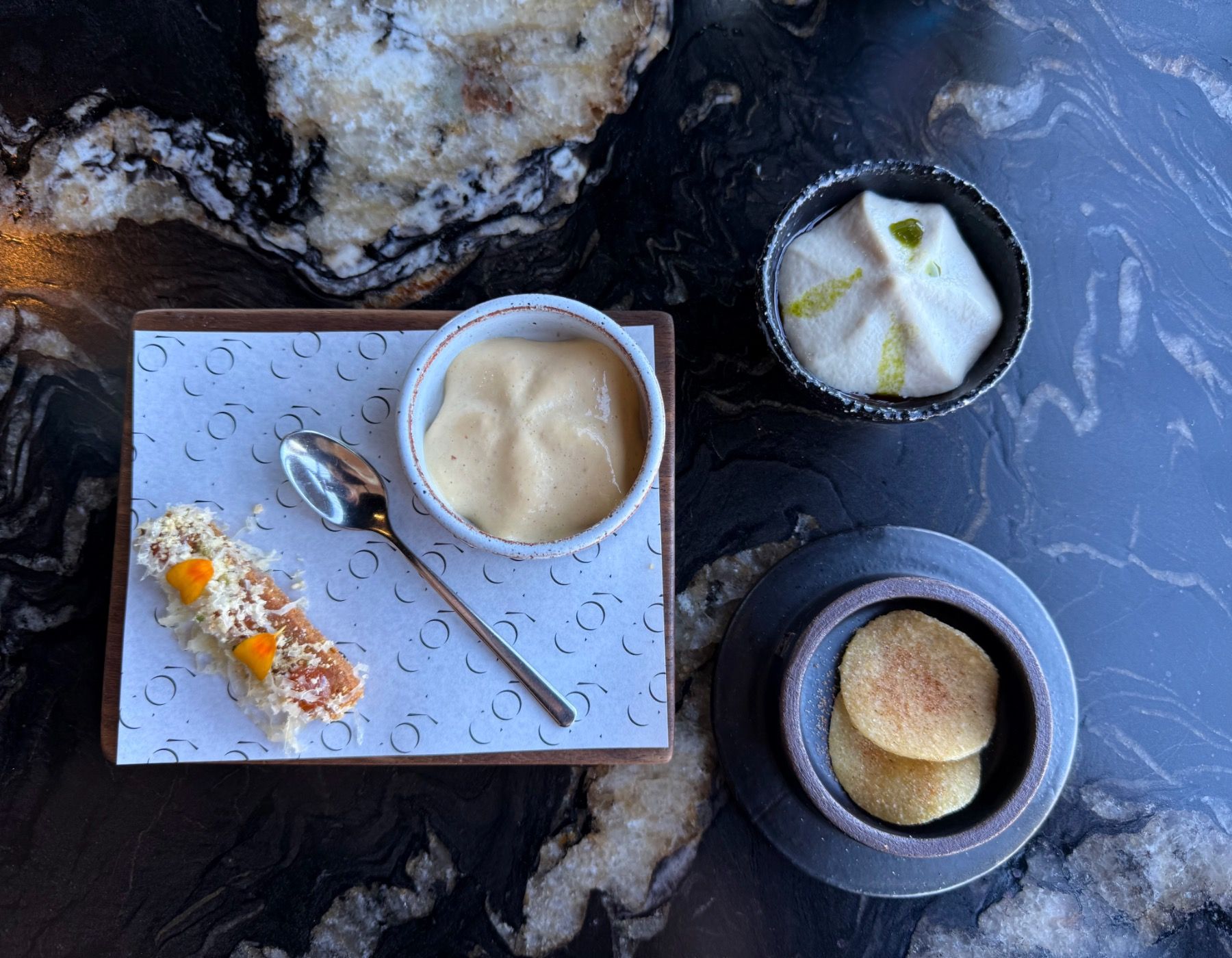 Amuse-bouche selection with maize chips, tahini dip and smoked Stanford croquette at Coy