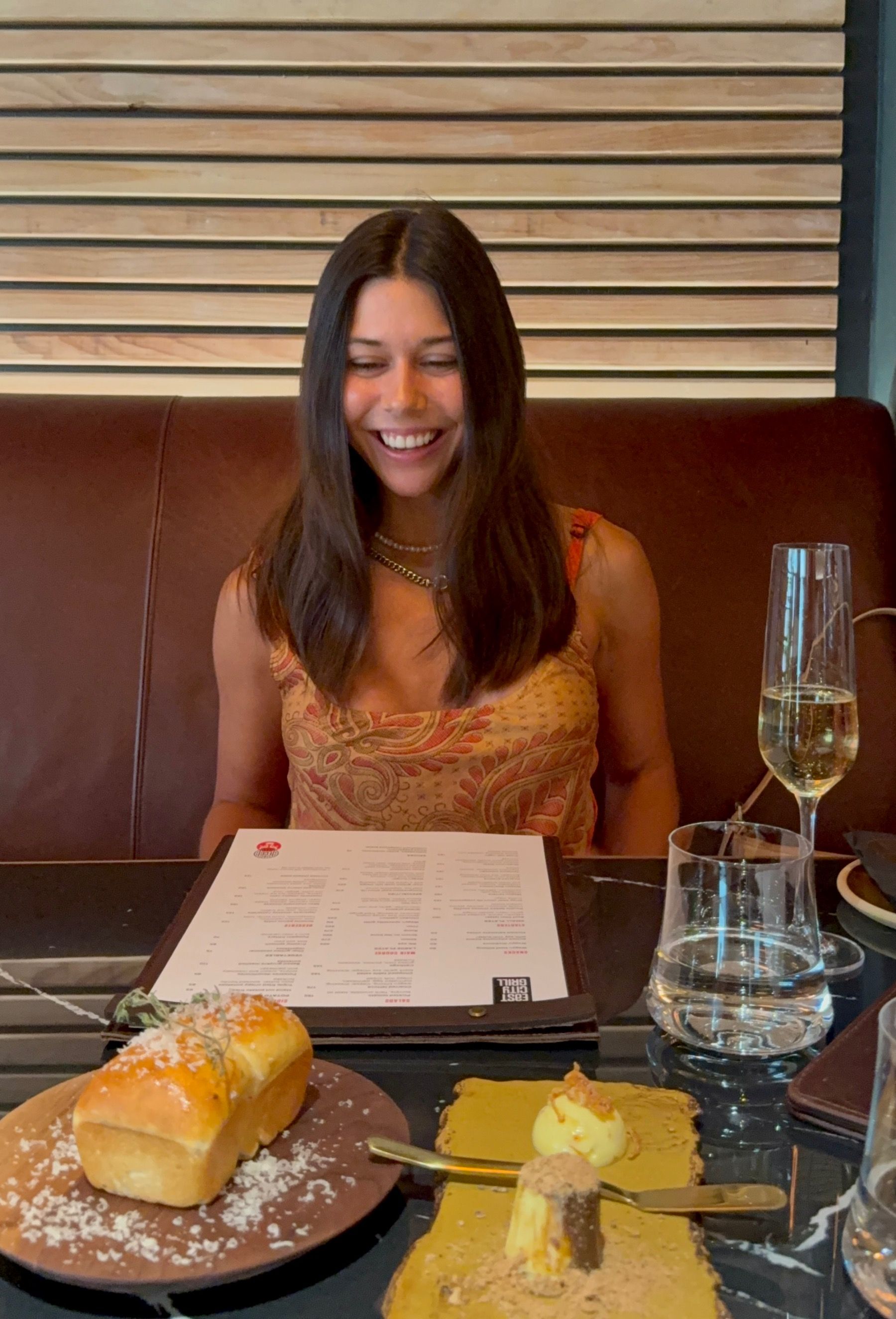 Paige Ellis Green smiling with complimentary mosbolletjies dressed in Parmesan at East City Grill