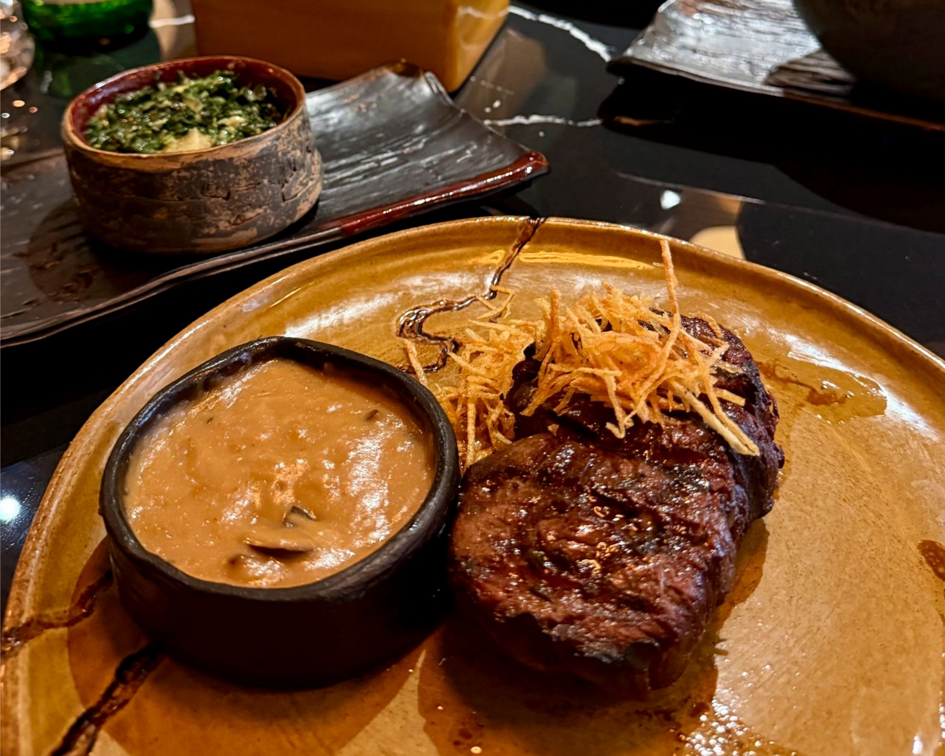 Medium-rare fillet brushed with wagyu fat, exotic mushroom sauce and creamed spinach with pear