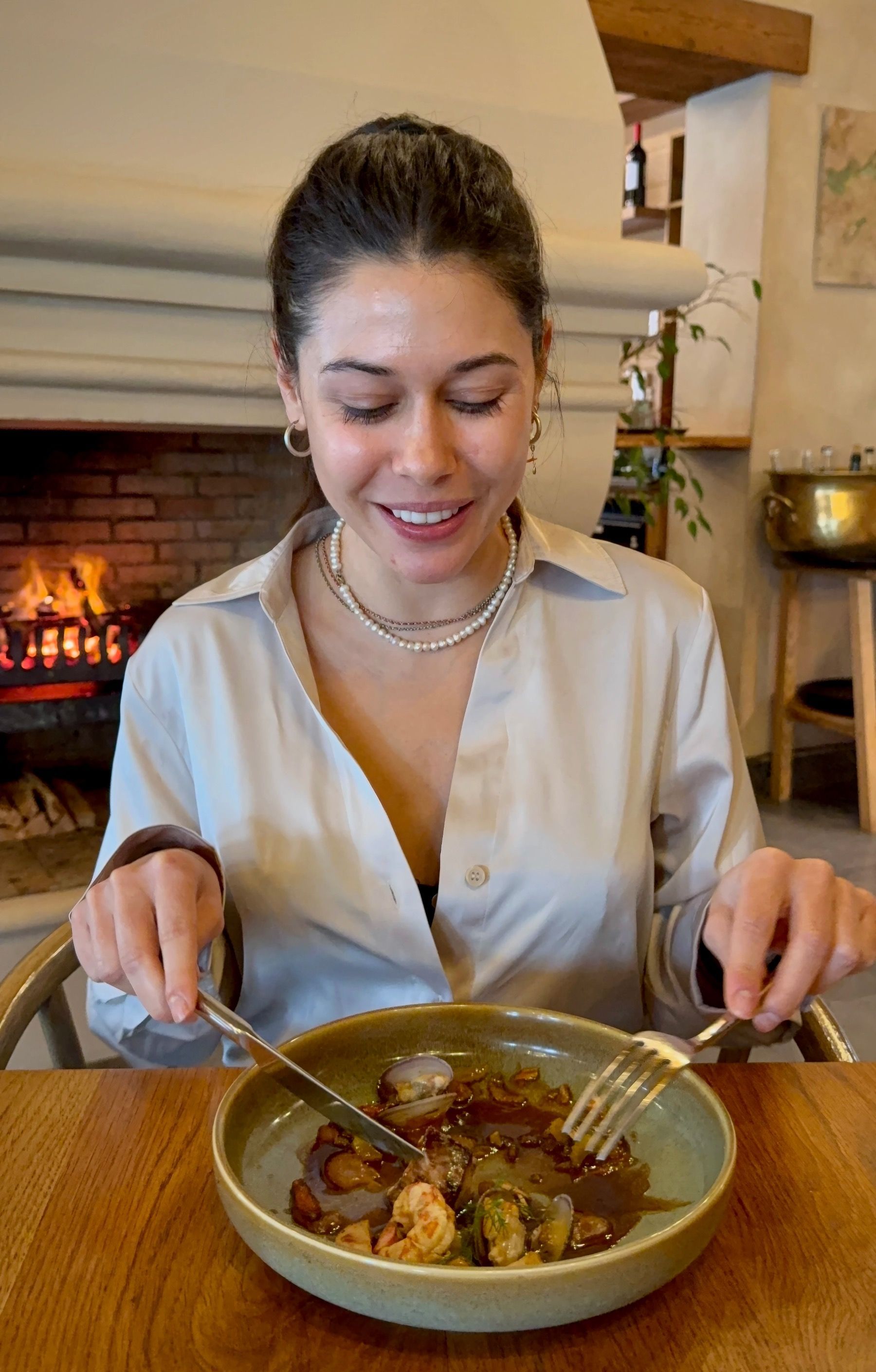 Paige tasting pan-seared sea bass at Eleven Franschhoek