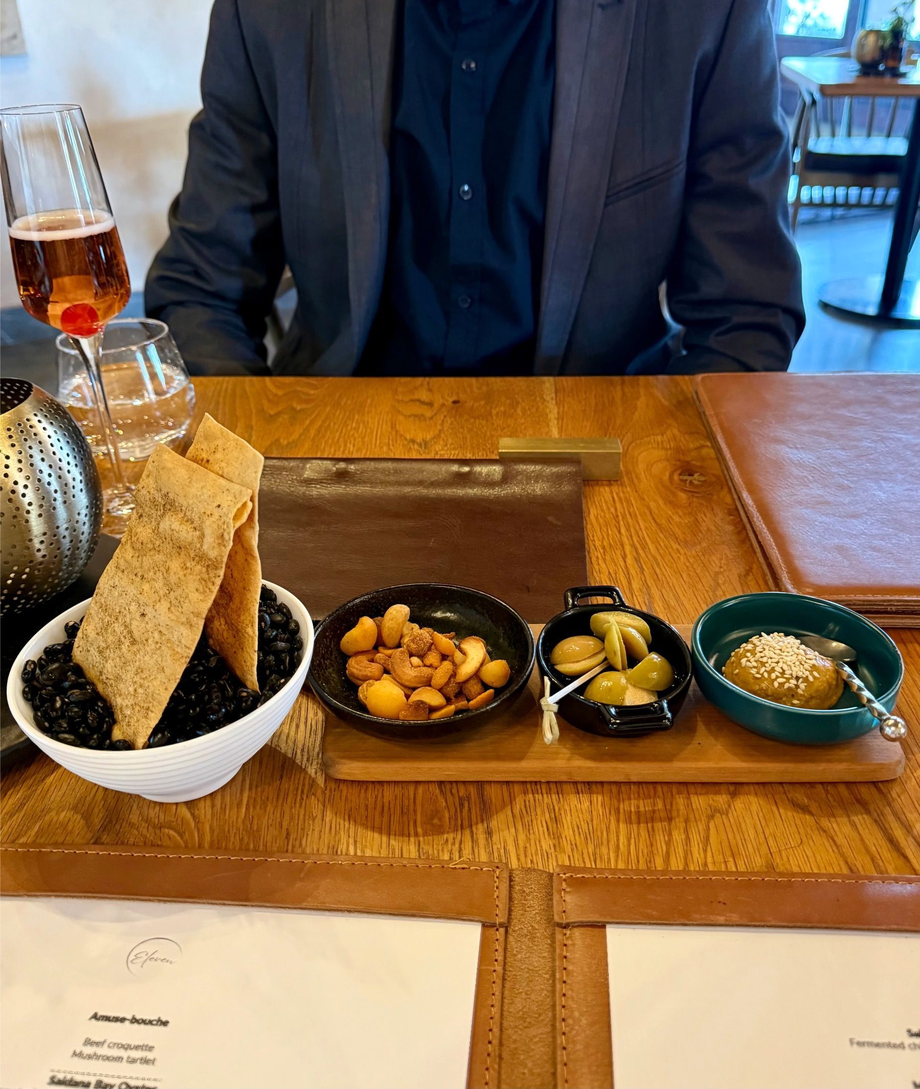 Chef’s snack selection with spiced nuts and small bites at Eleven Franschhoek
