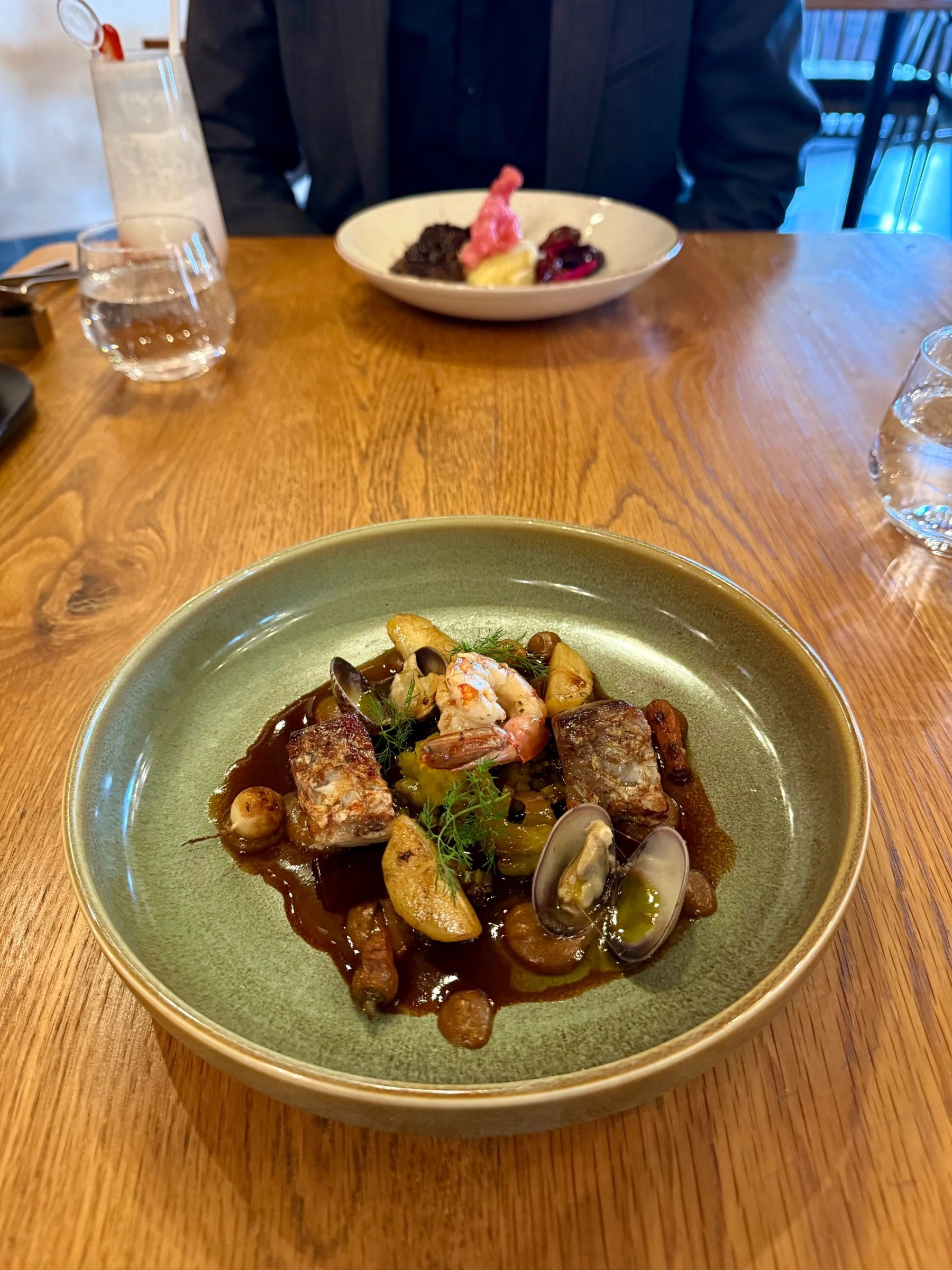 Pan-seared sea bass with prawn, clams and rich seafood sauce at Eleven Franschhoek