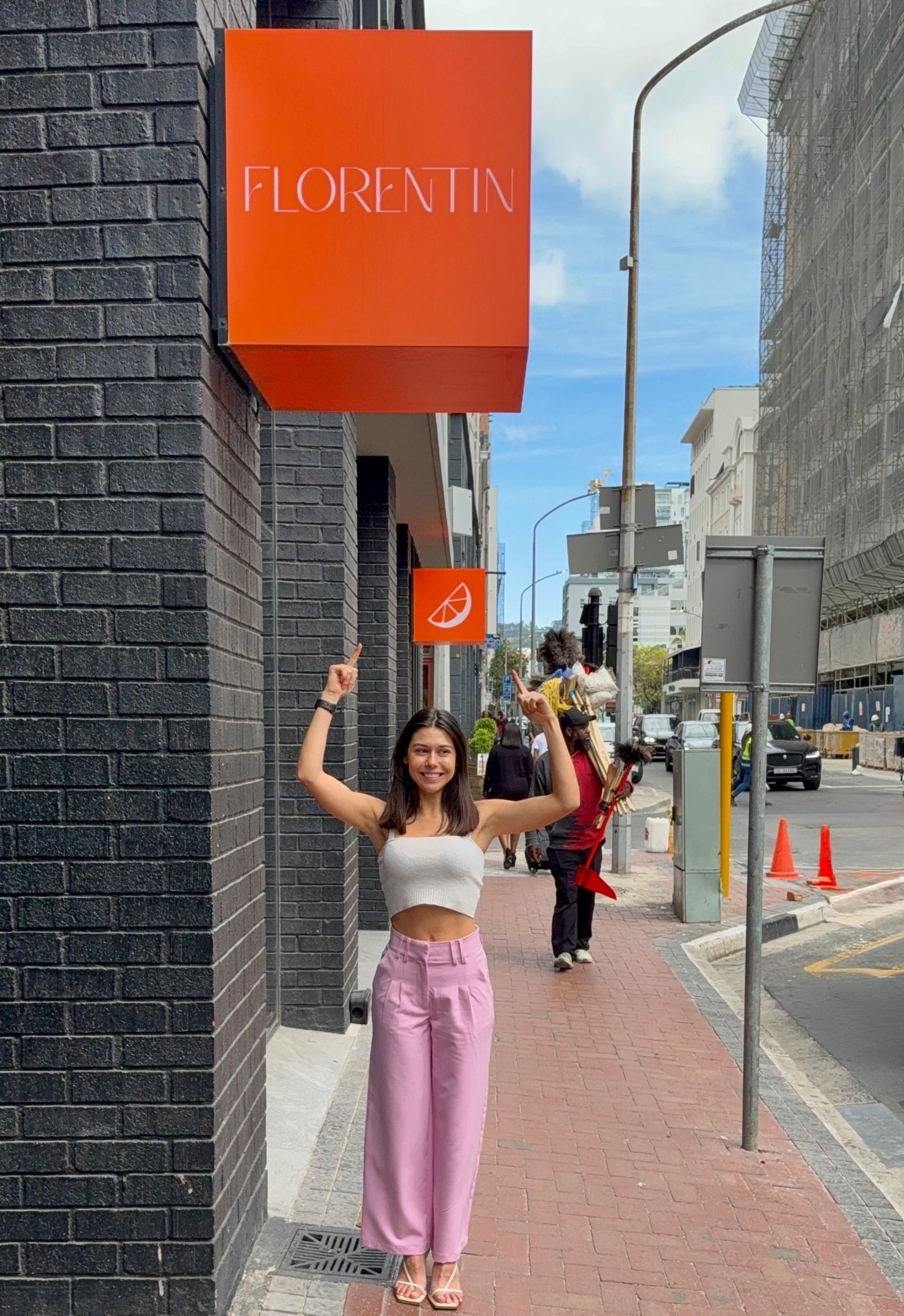 Paige pointing at Florentin sign in Loop Street
