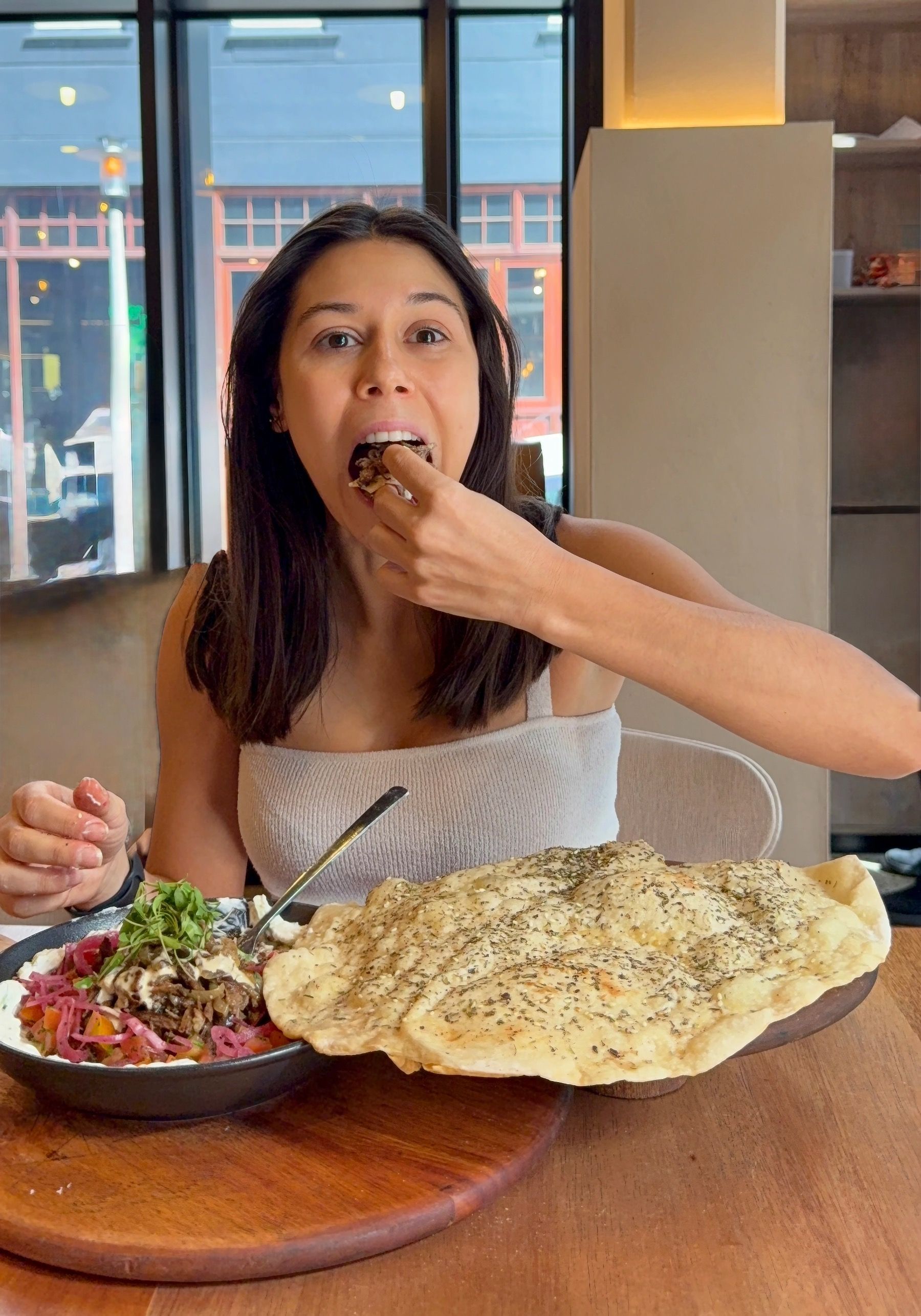 Paige eating kwama dish at Florentin Cape Town in sunlit Bree Street interior