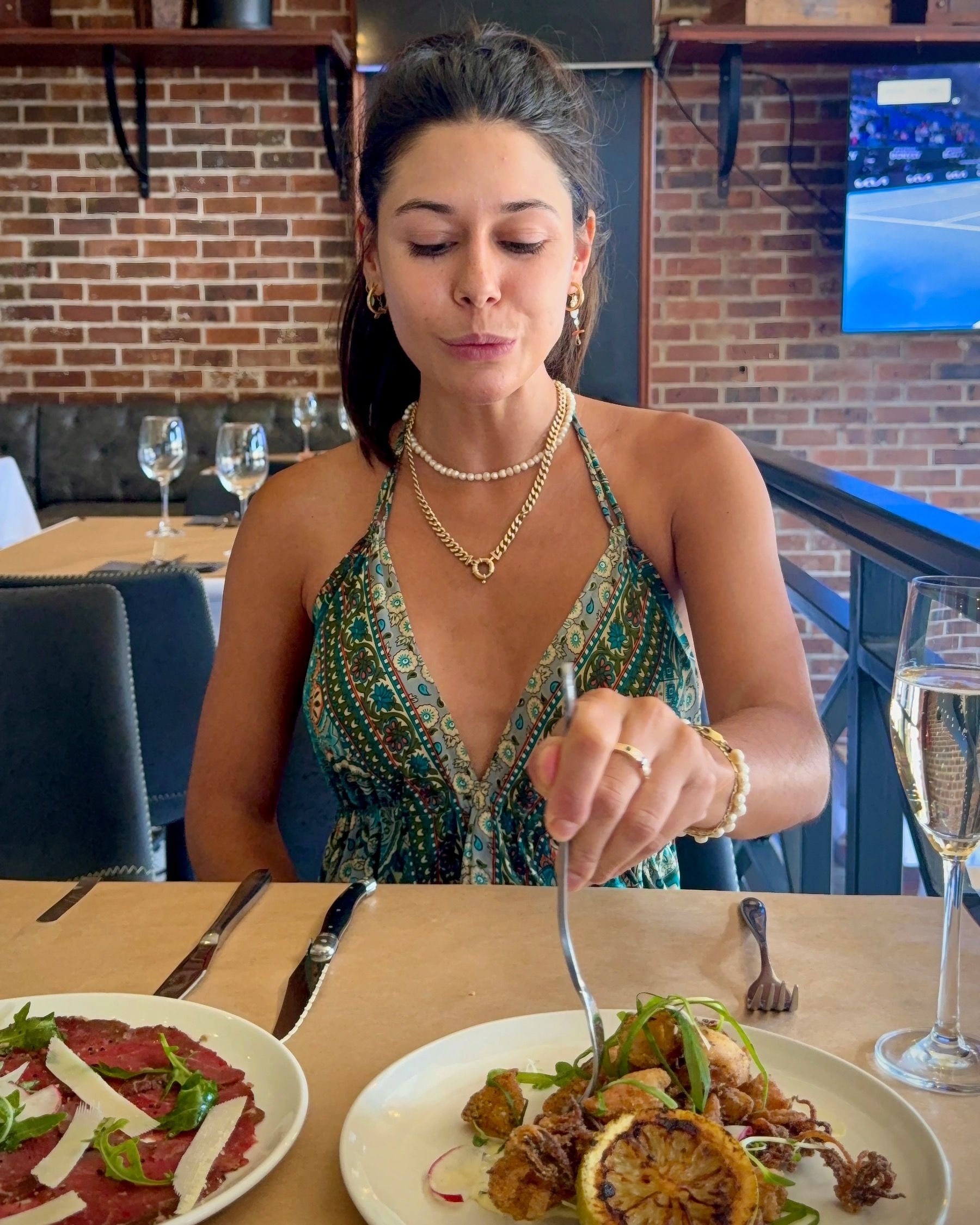 Paige enjoying salt and pepper calamari with lemon aioli and beef fillet carpaccio with parmesan and fennel at HQ Steakhouse