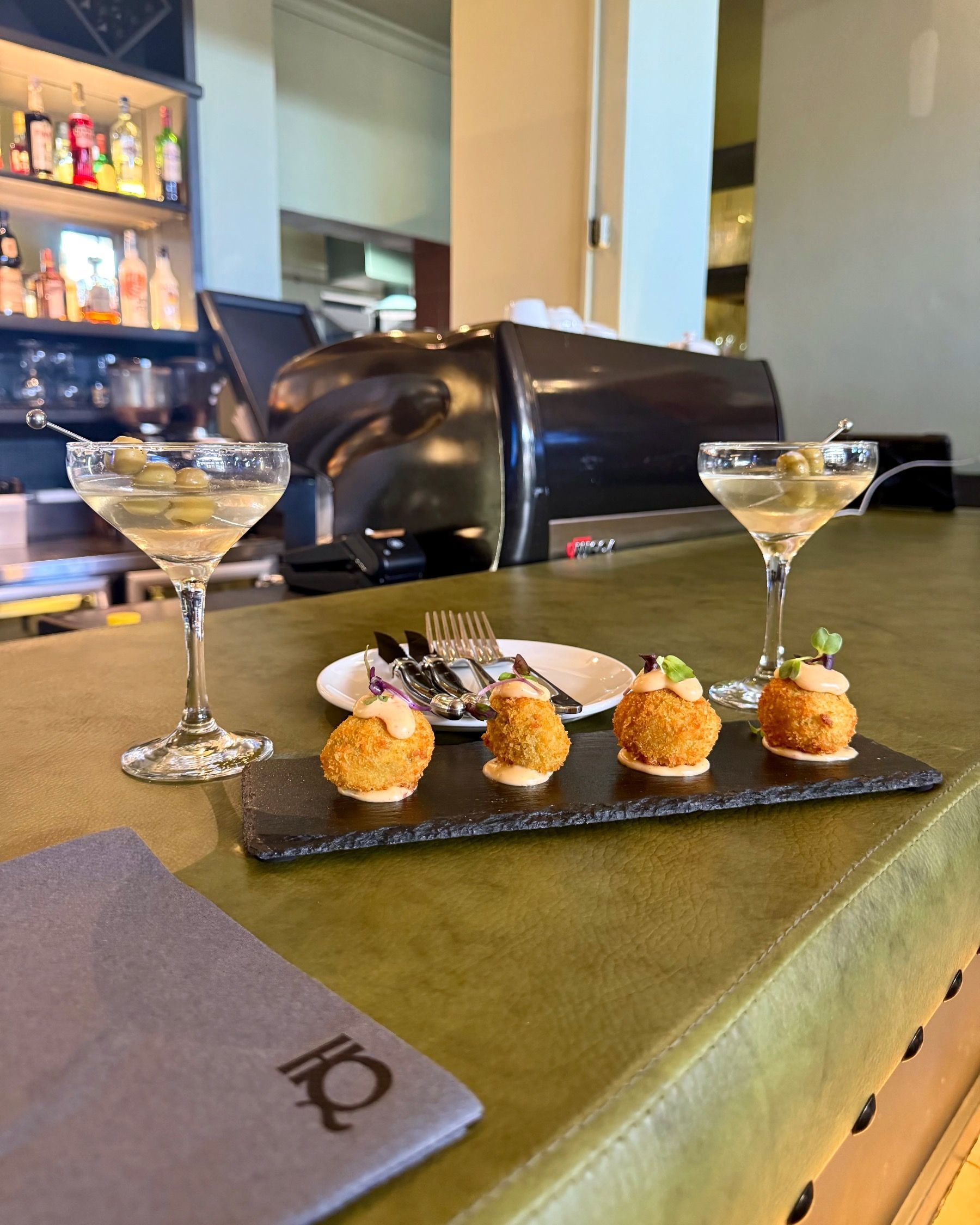 Cheesy chilli poppers with properly dirty martinis topped with three green olives at HQ Steakhouse bar in Century City