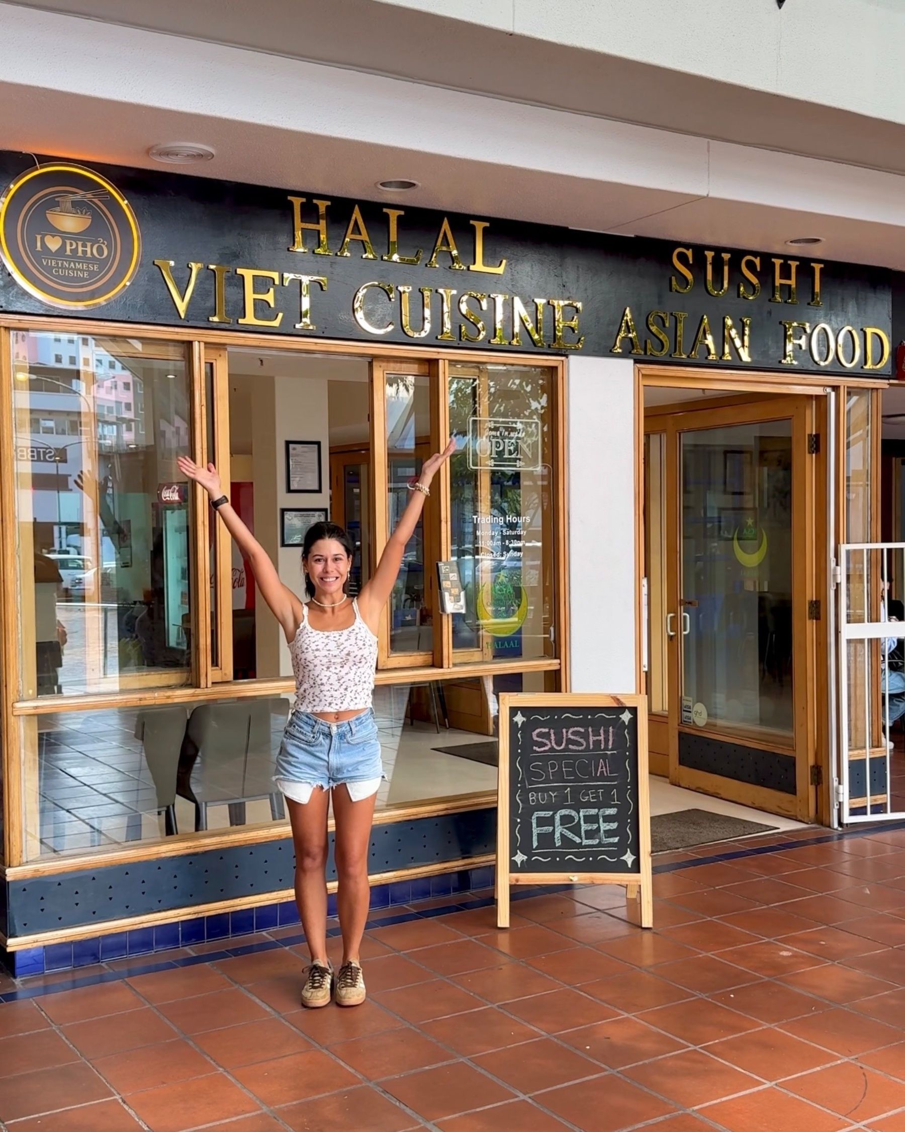 Paige next to I Love Pho sign at I Love Pho