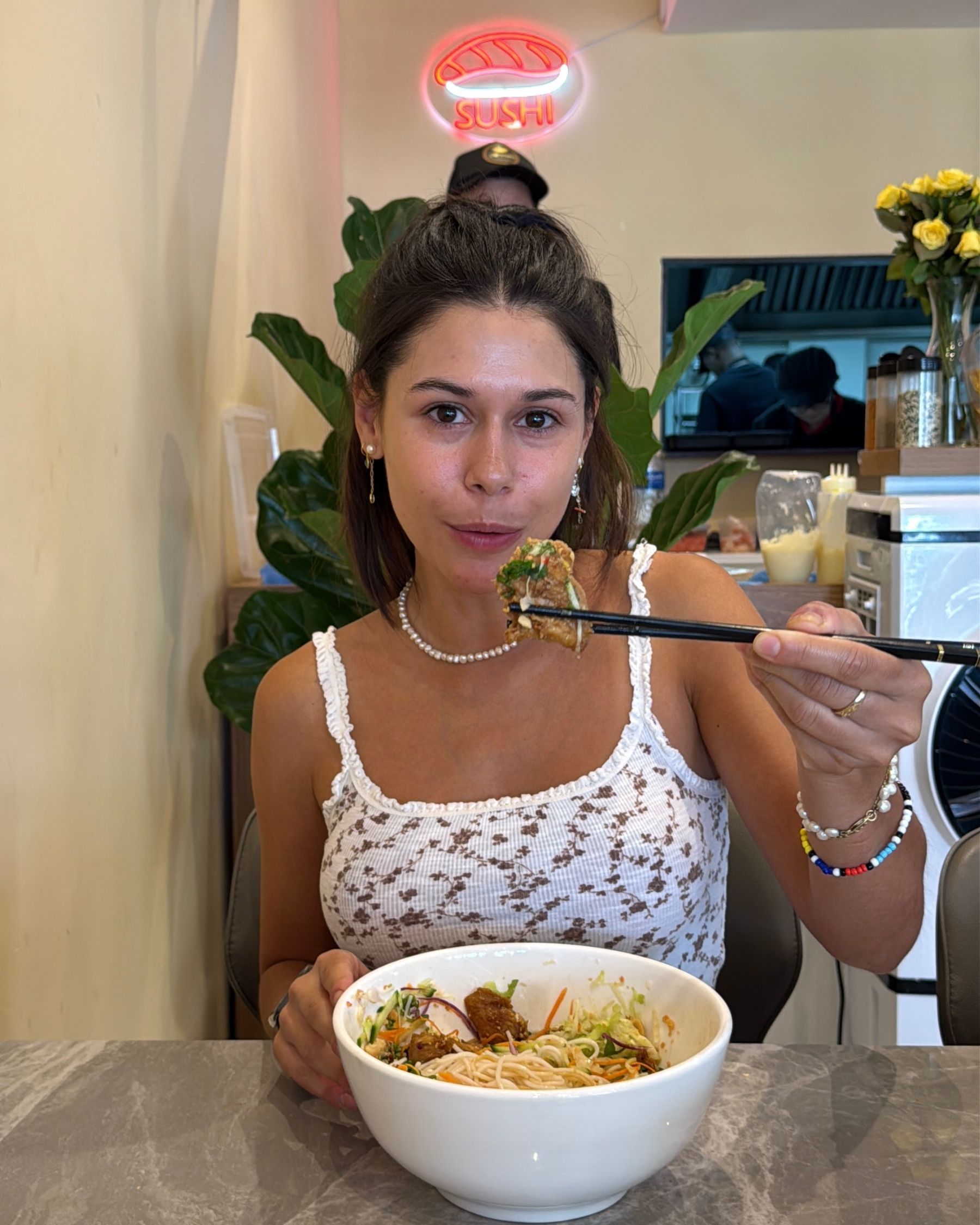 Paige eating chicken vermicelli noodle bowl
