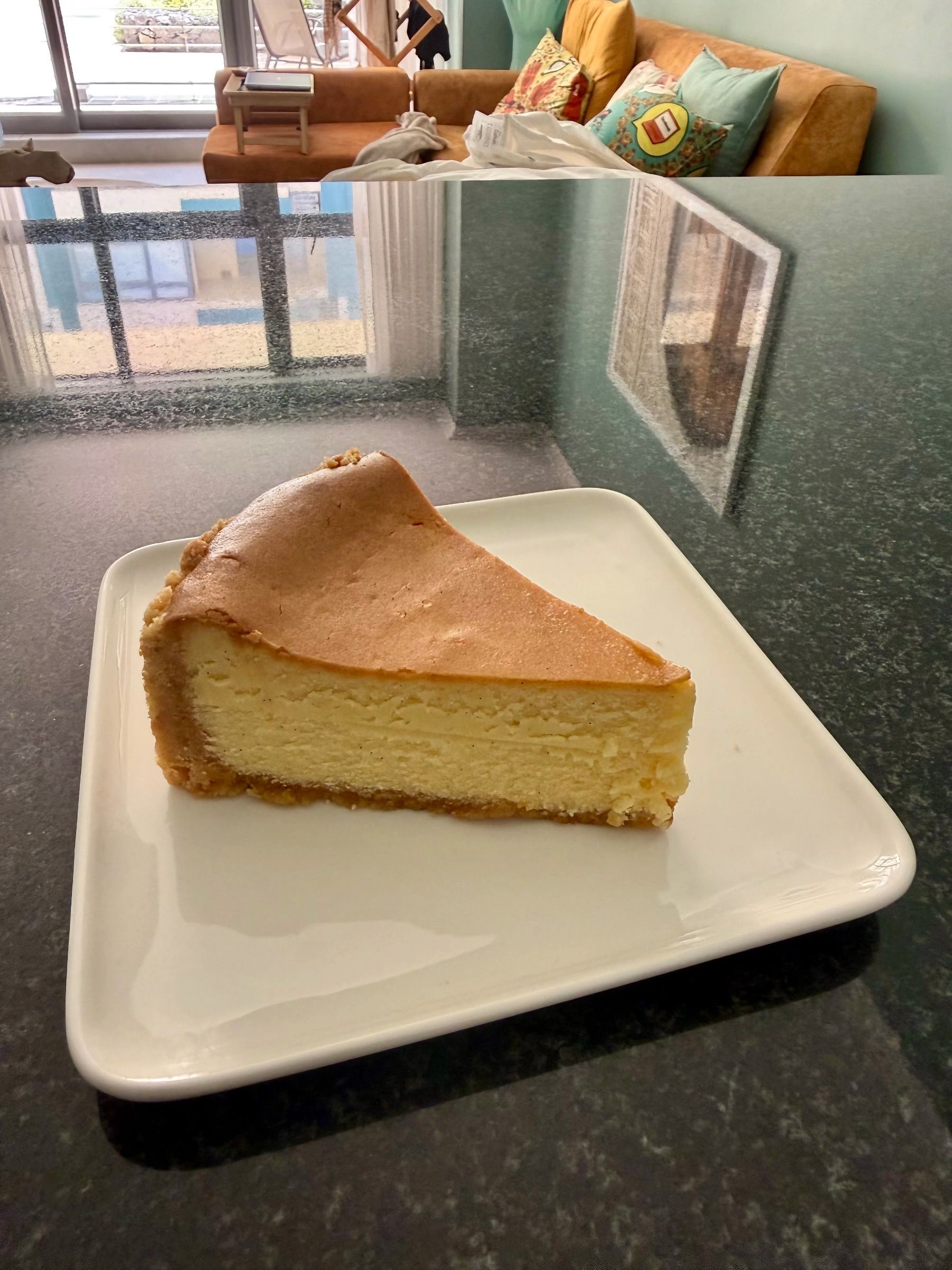 Slice of white chocolate cheesecake at Lazari Café in Gardens, Cape Town, served on a simple white plate