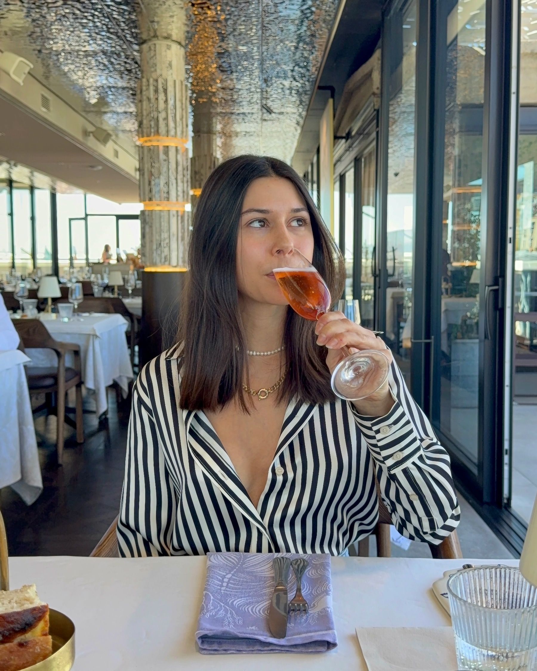 Paige sipping sparkling wine at Marble Cape Town with Table Mountain views at the V&A Waterfront
