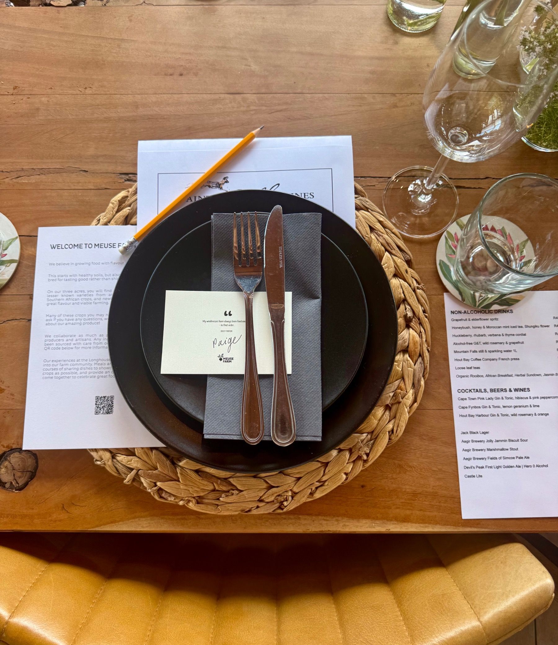 Elegant long wooden table setting with handwritten name card at Meuse Farm x Painted Wolf Wines pairing dinner.