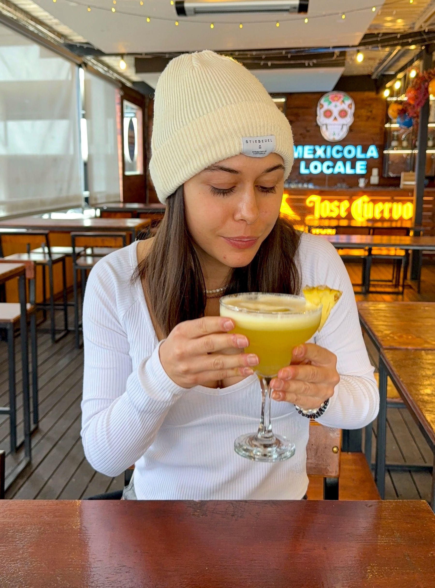 Paige drinking a fresh pineapple margarita at Mexicola Locale Cape Town
