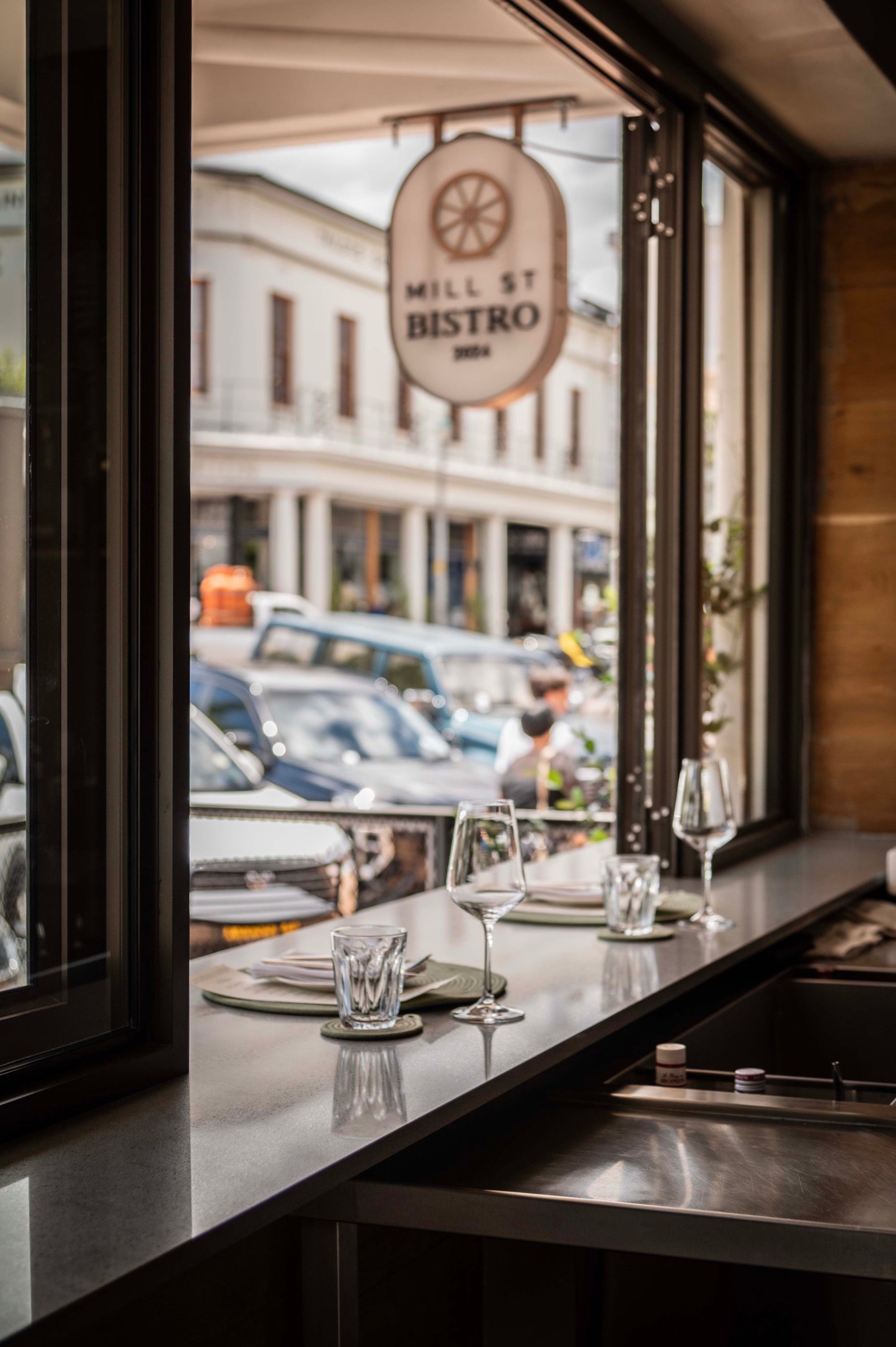 Mill Street Bistro wine deck in Stellenbosch overlooking historic Long Street with elegant white table settings 
