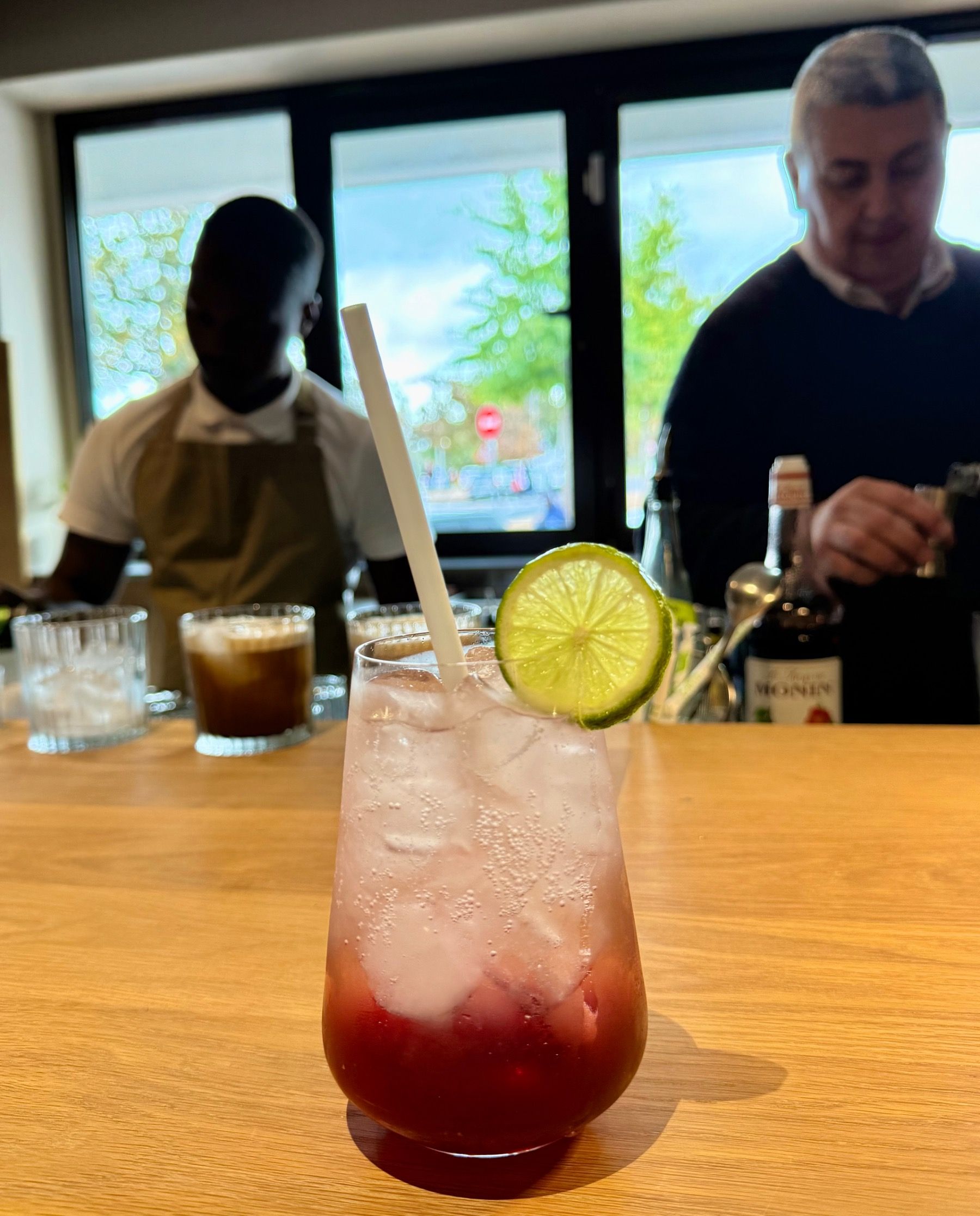 Pomegranate spritz mocktail at Mill Street Bistro with fresh lime garnish served during winter menu preview in Stellenbosch
