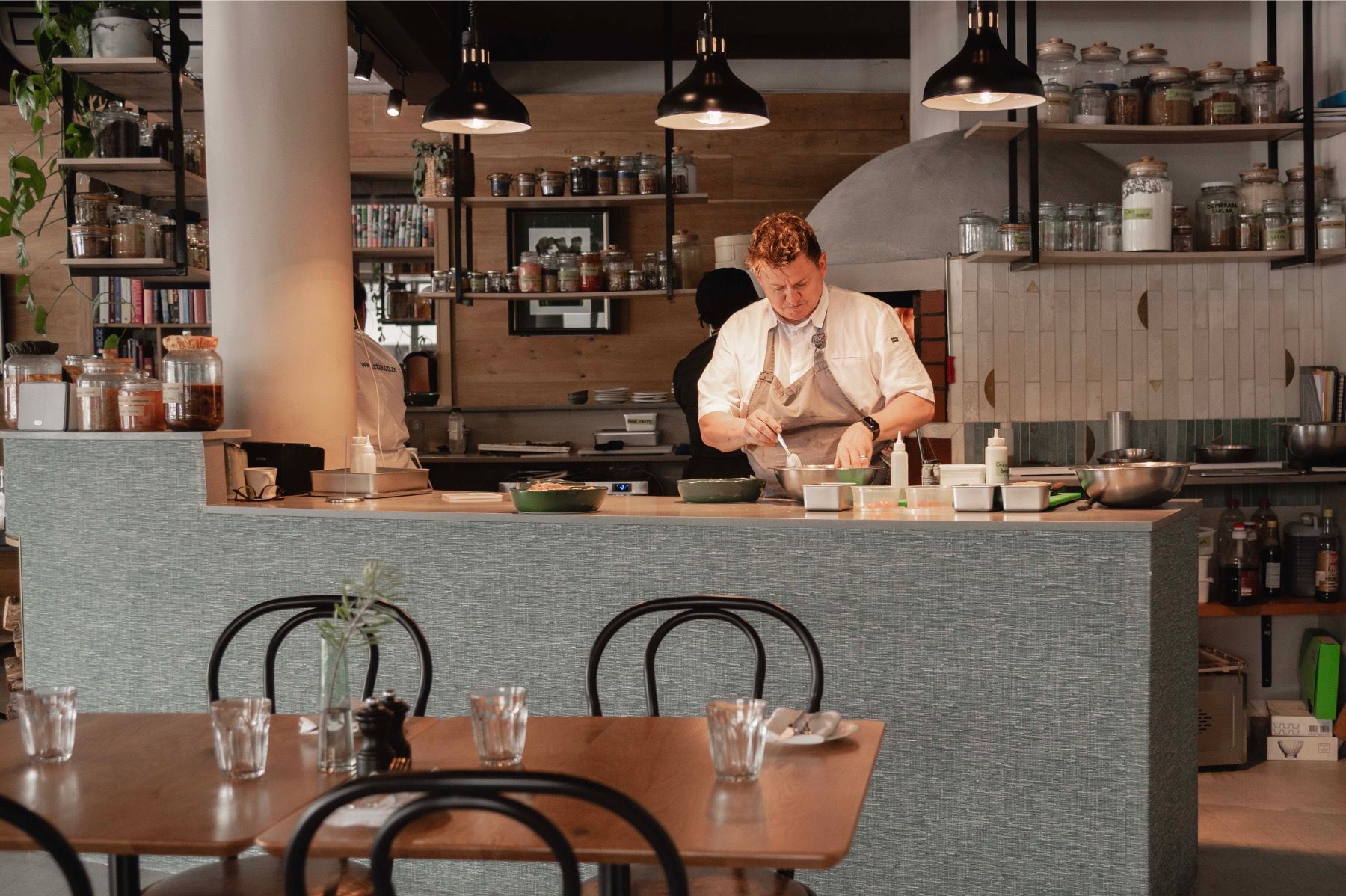 Mill Street Bistro interior in Stellenbosch with warm wood finishes, open kitchen and elegant dining space