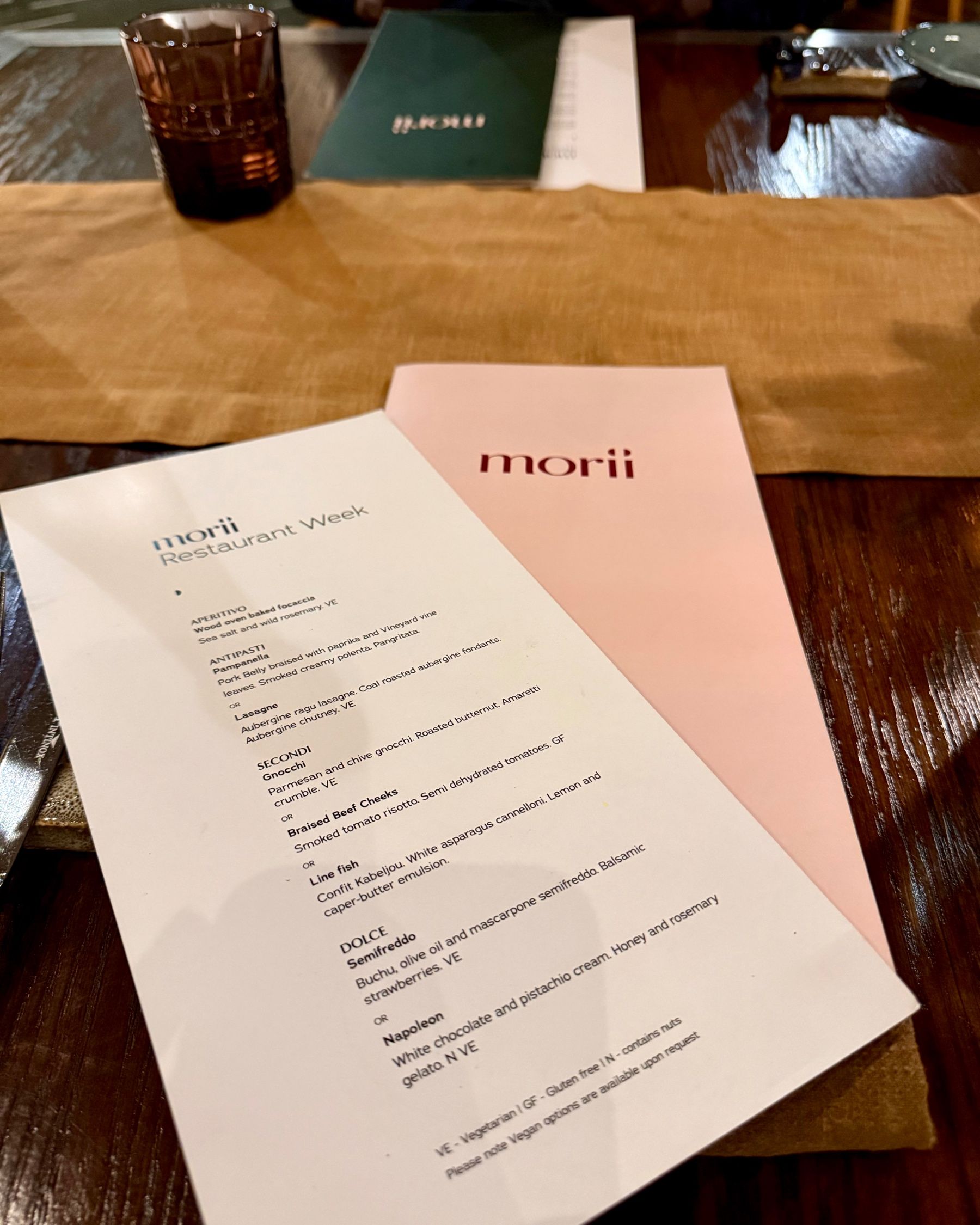 Paige is smiling at Ramenhead Cape Town with sparkling water