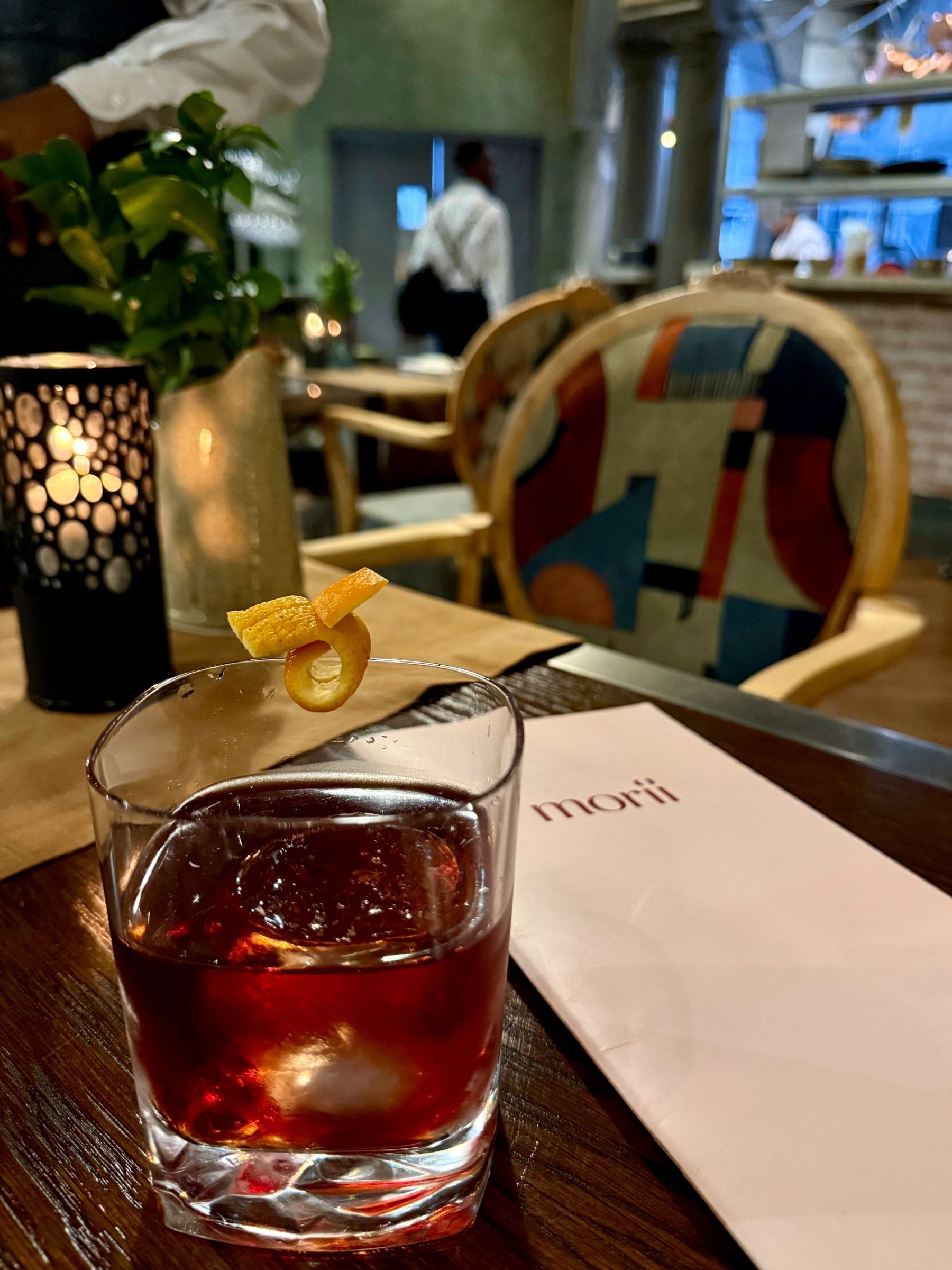 Paige is holding a lychee rose martini at Ramenhead Cape Town