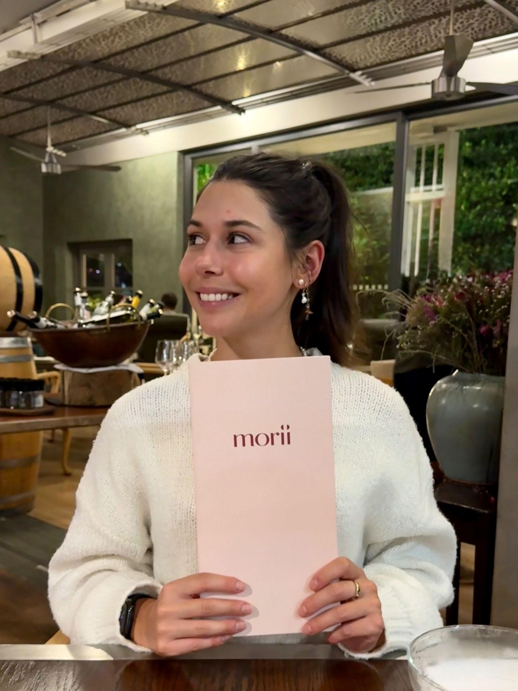 Paige is standing outside the Ramenhead Cape Town entrance at night
