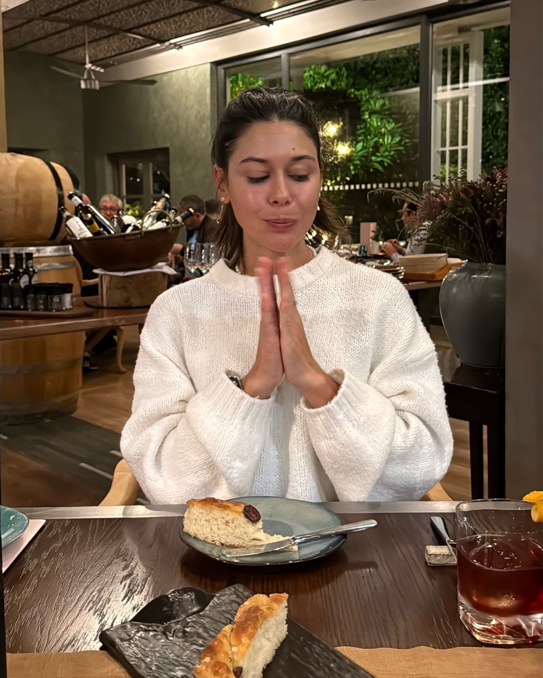 Paige is sipping ramen broth from the bowl at Ramenhead Cape Town