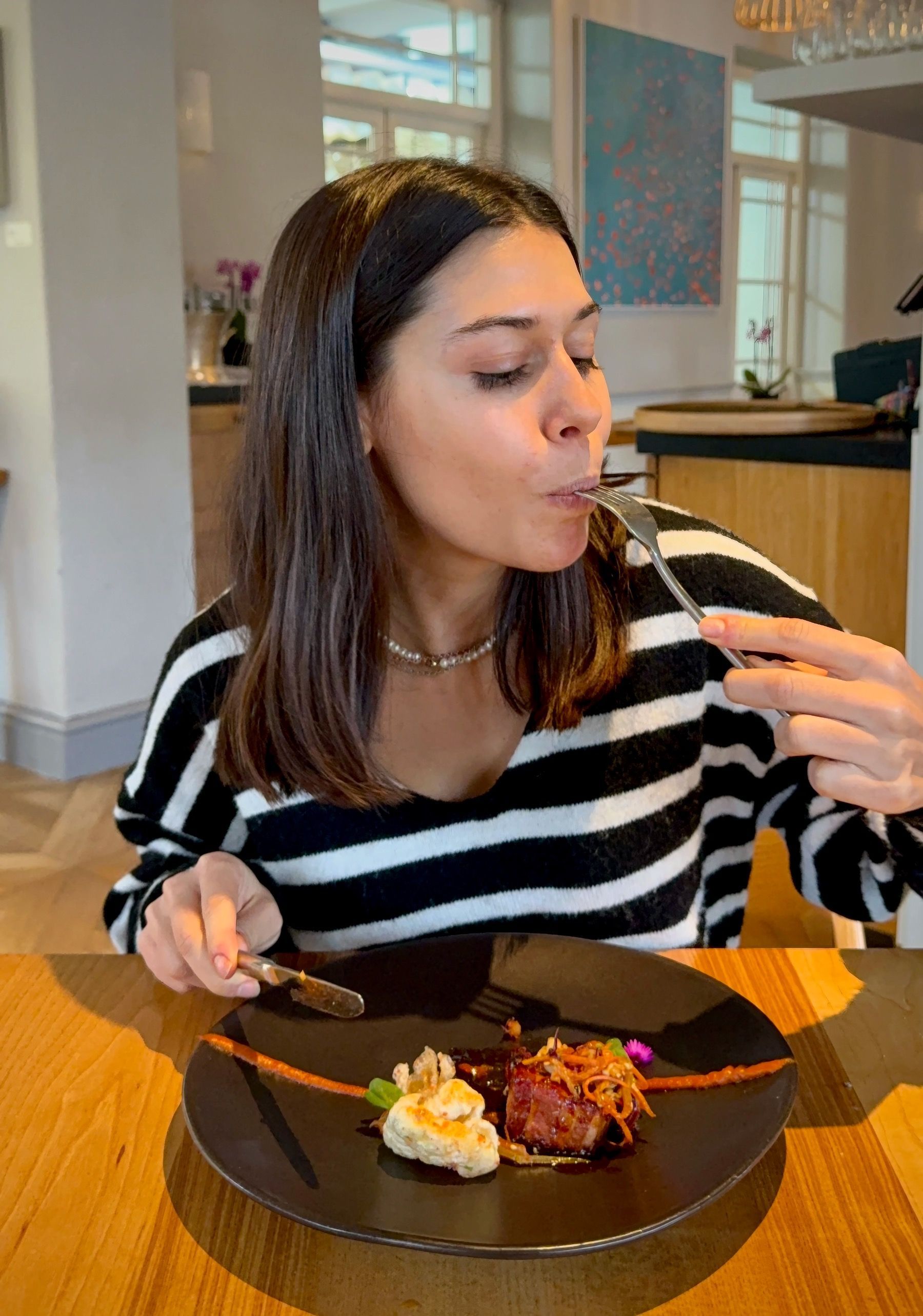 Paige enjoying pork rib yakinuki main course at Oku.