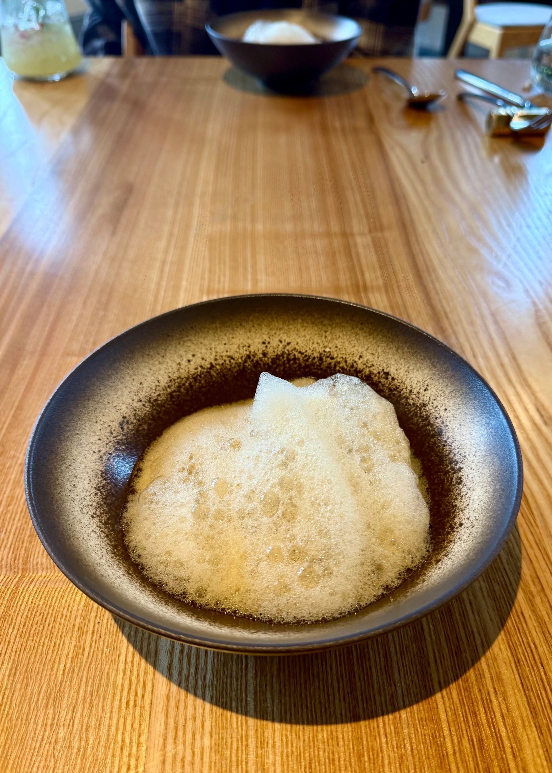 Steamed dumplings served in a minimalist ceramic bowl at Oku Franschhoek.