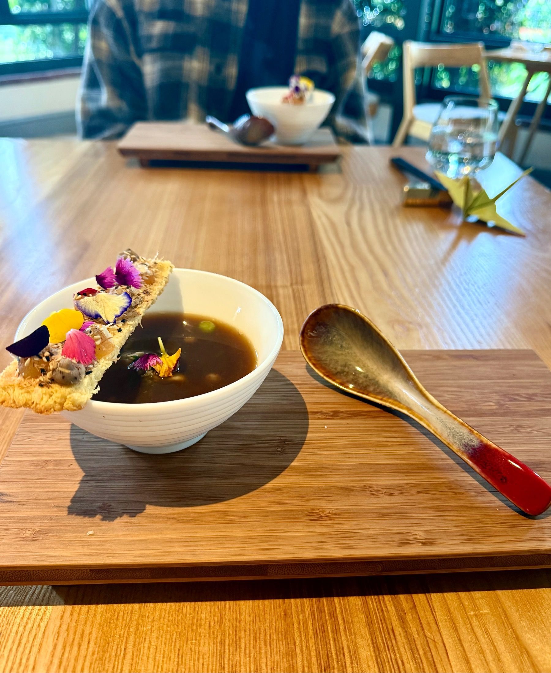 Rich beef bone broth with marrow elements served in ceramic bowl.
