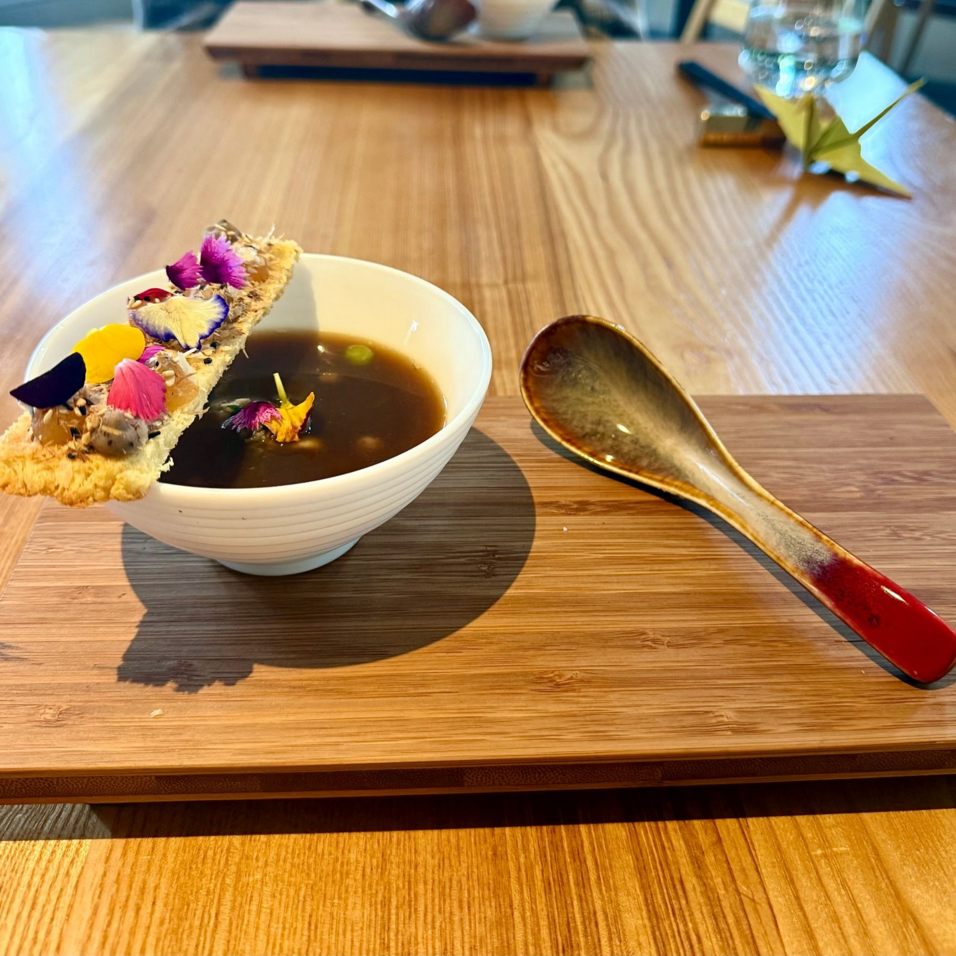 Rich beef bone broth with marrow elements served in ceramic bowl.
