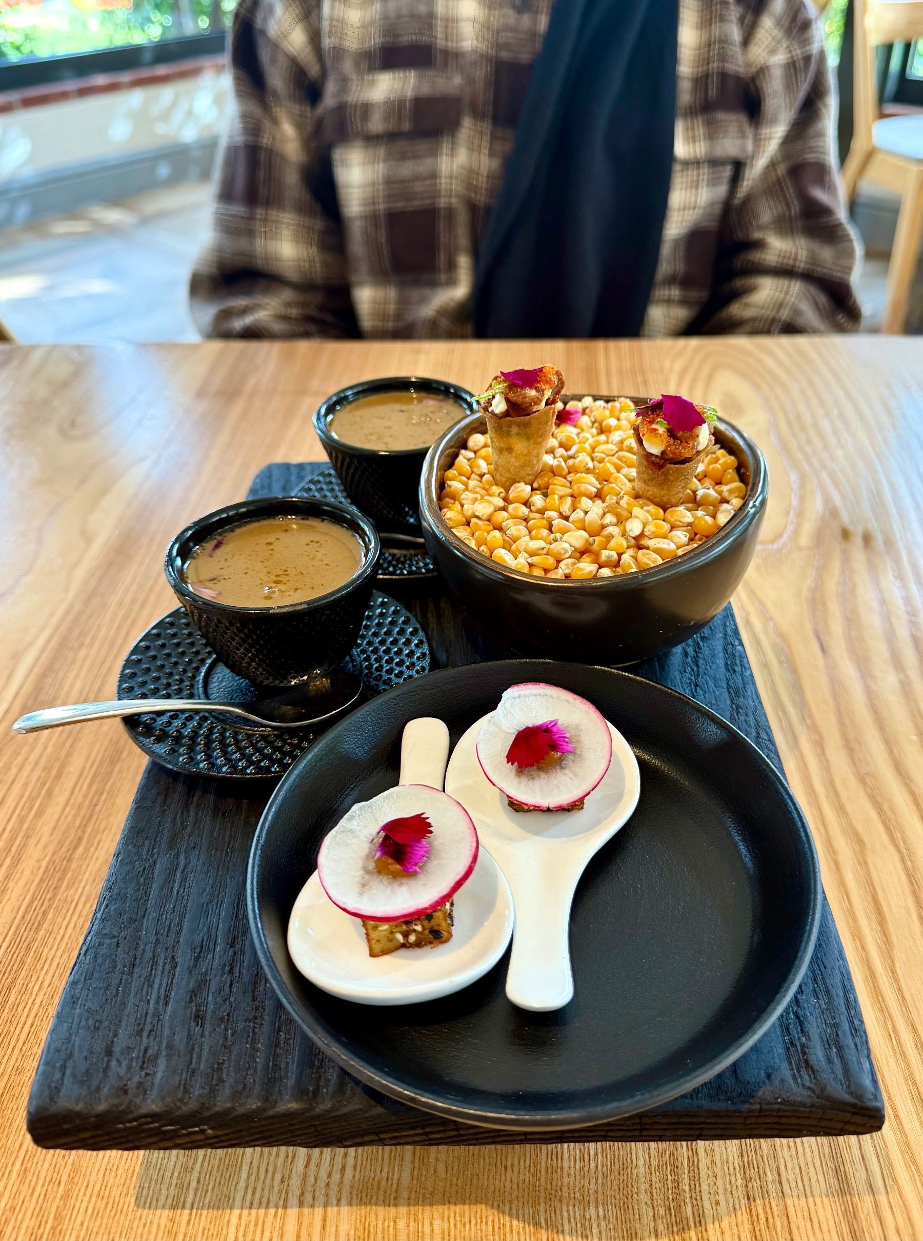 Three Japanese-inspired amuse-bouches served in minimalist ceramic at Oku Franschhoek.