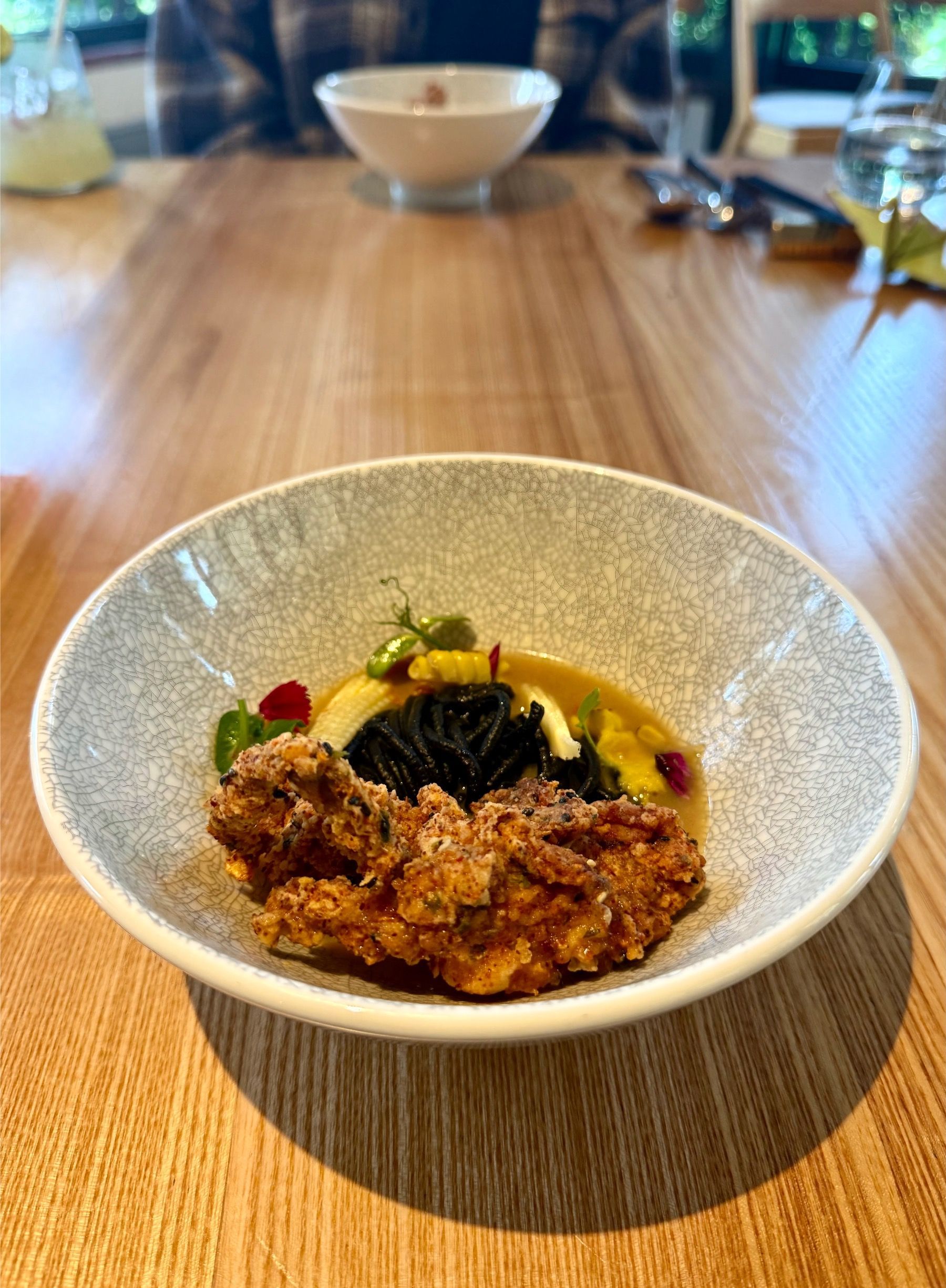 Soft shell crab with refined garnish and Japanese-inspired plating at Oku.
