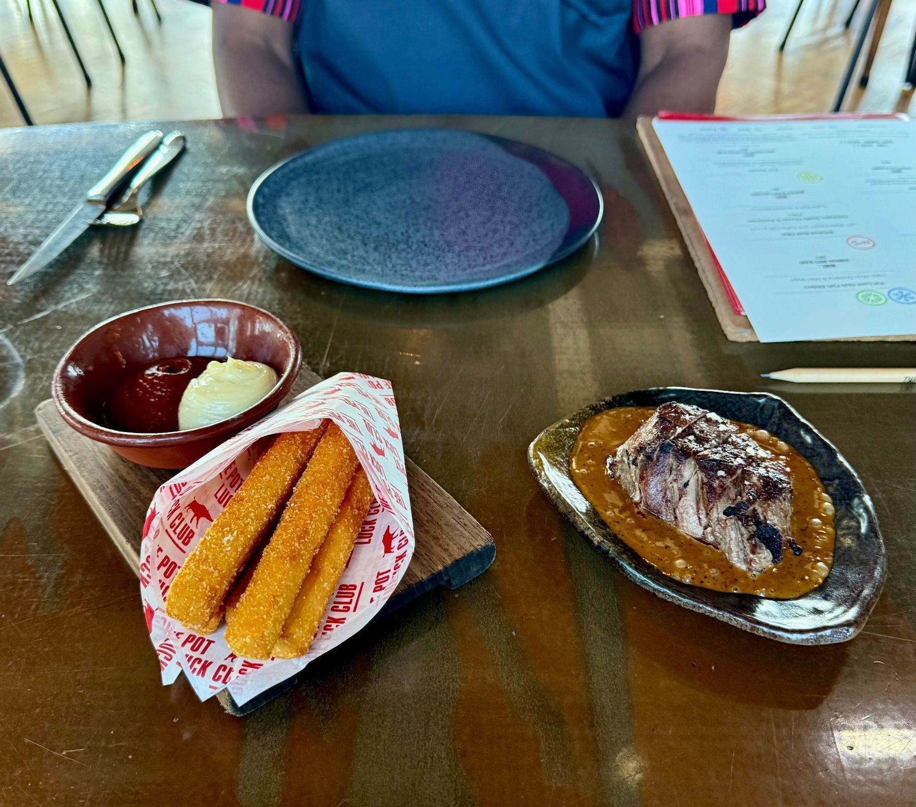 Smoked beef fillet with black pepper and truffle café de Paris, chickpea goat’s cheese and fries