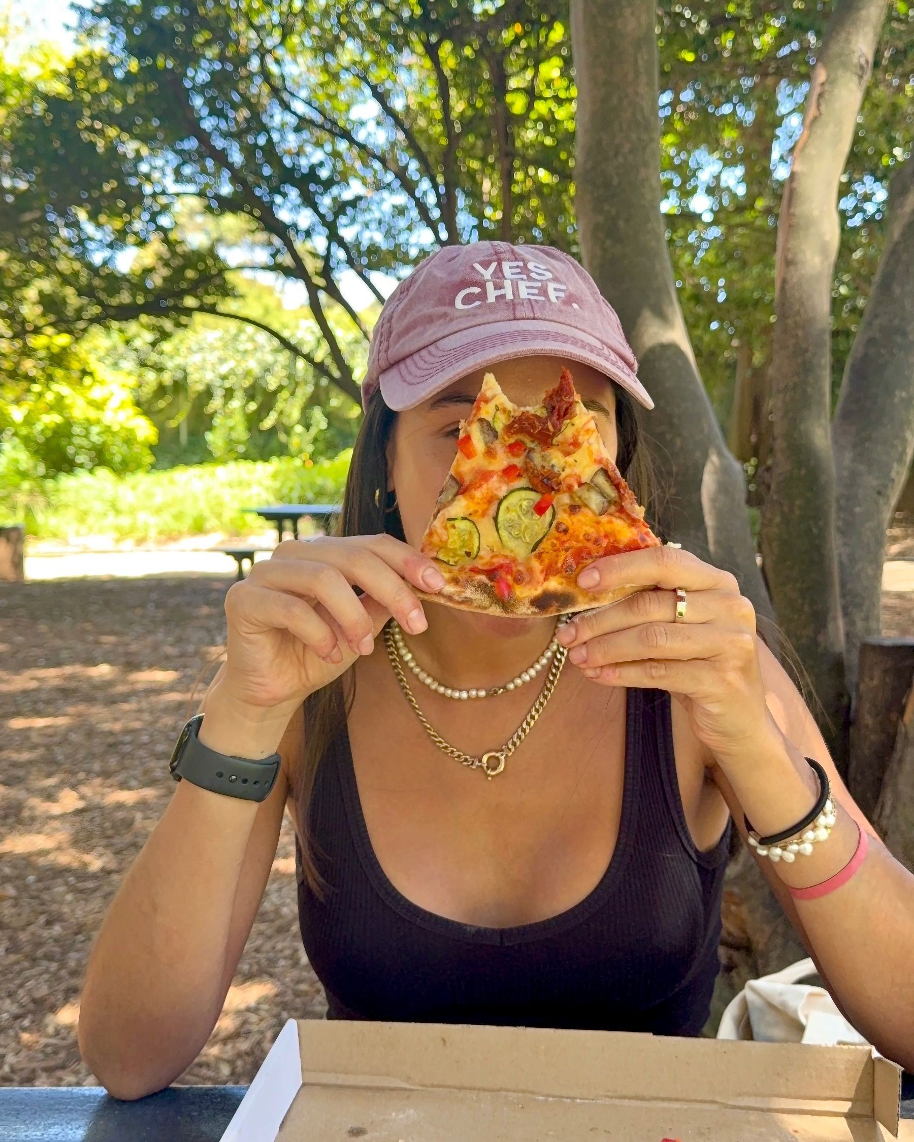 Paige holding a slice of Contadina pizza at Piccolo Posticino Rondebosch