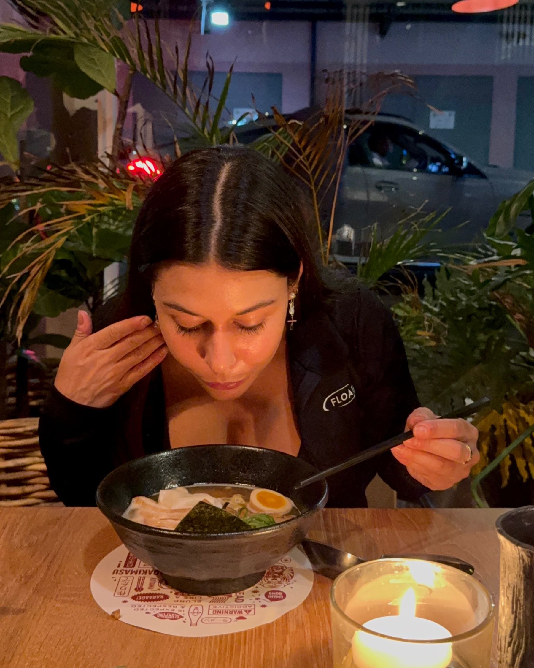 Paige is smelling ramen at Ramenhead Cape Town