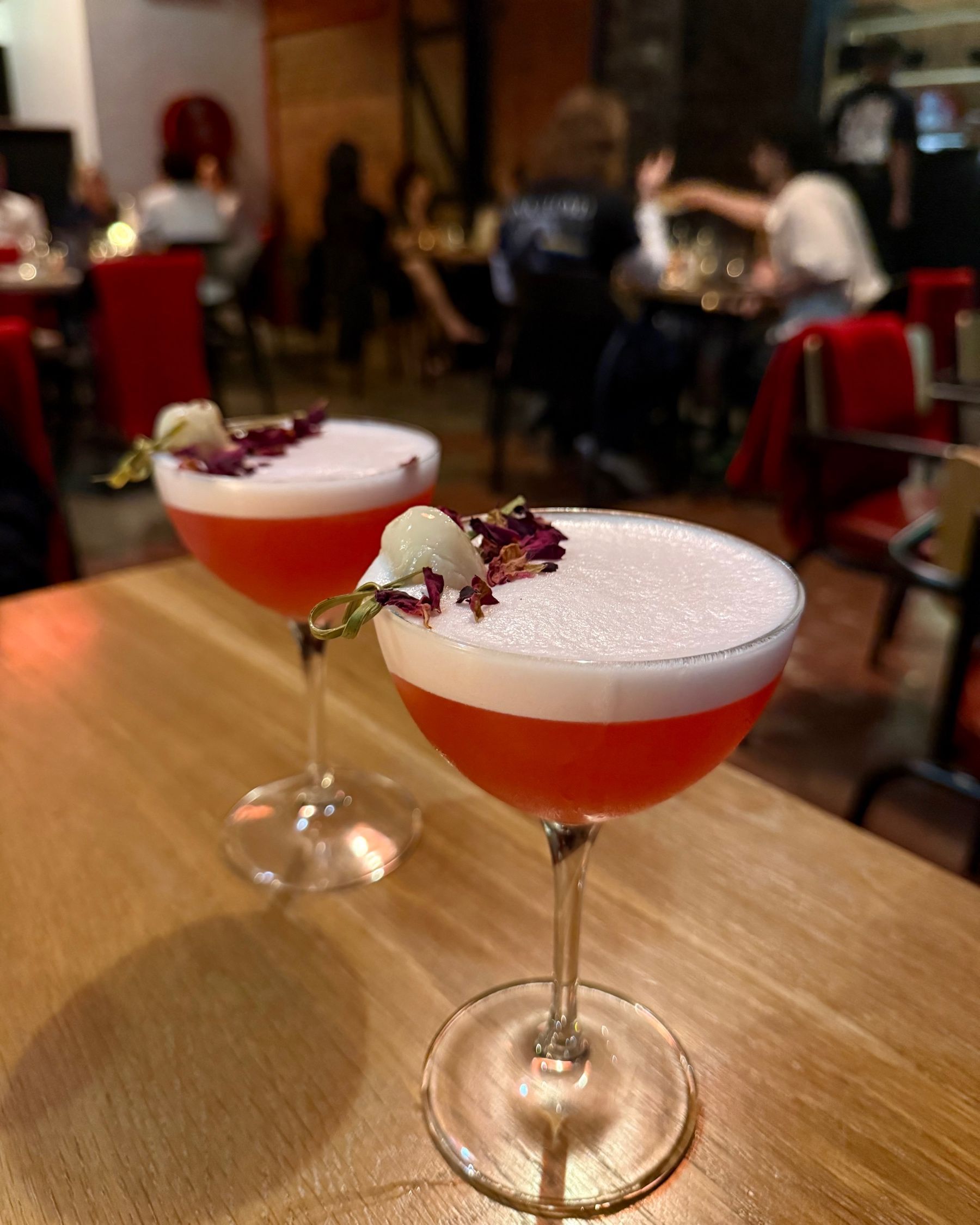 Lychee rose martinis at Ramenhead Cape Town on a wooden table