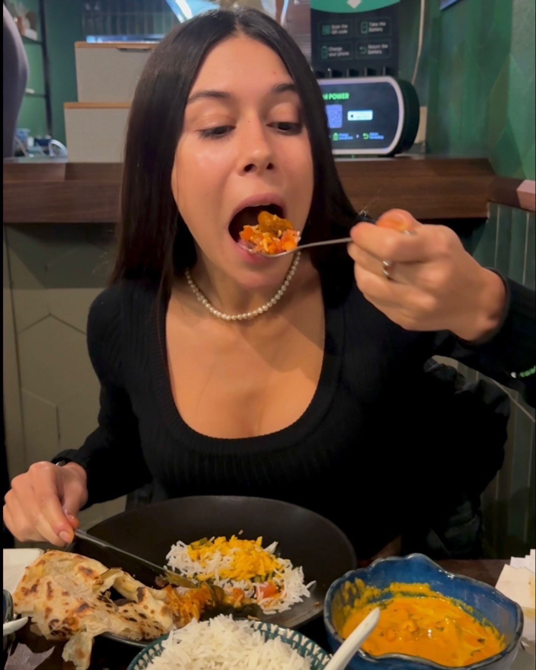 Paige is eating lamb curry at Sundoo Sea Point