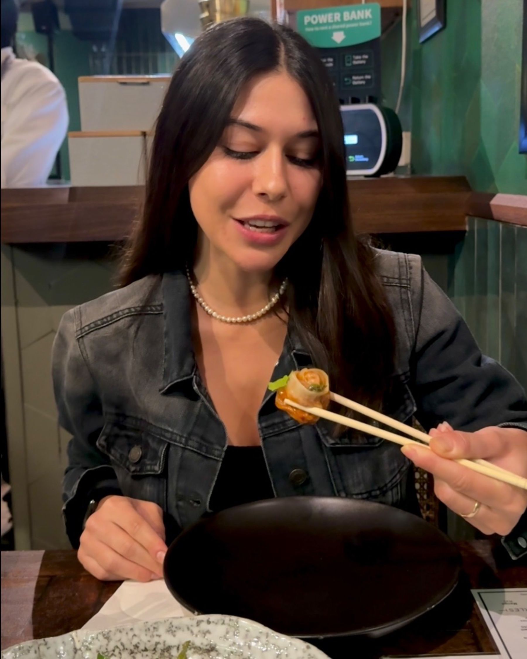 Paige is eating a momo at Sundoo Sea Point